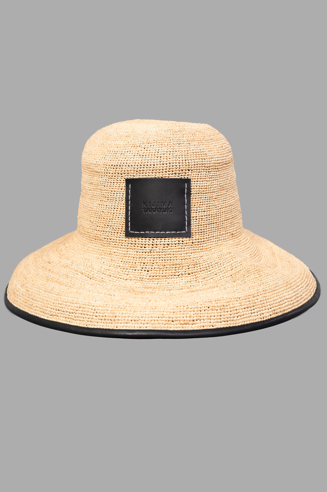 Kijima Takayuki Straw Mushroom Hat in beige with black trim, showcasing a sleek design and fine raffia craftsmanship.