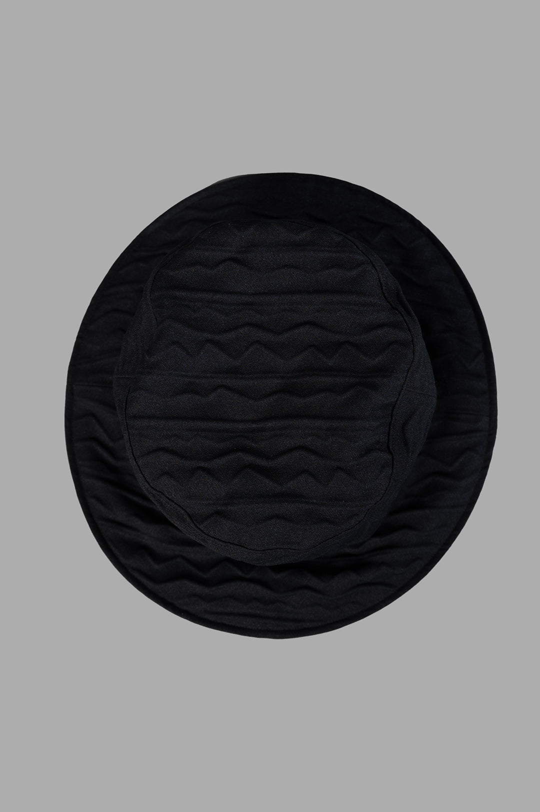 Kijima Takayuki Textured Bucket Hat displayed from above, showcasing its intricate quilted pattern in black.