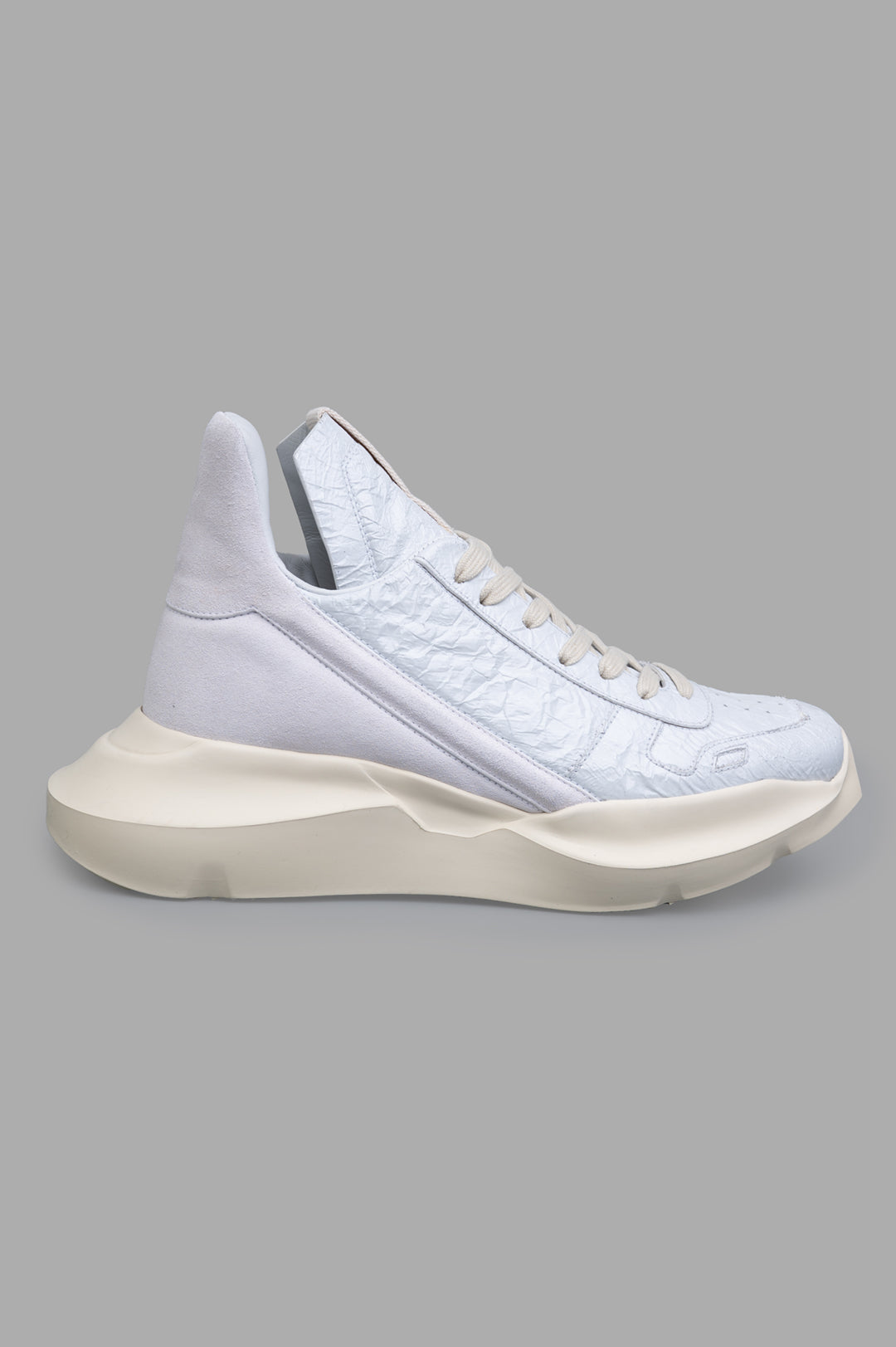 Rick Owens Hollywood Geth Runner, side view of white leather sneaker with angled stripe and geometric sole.