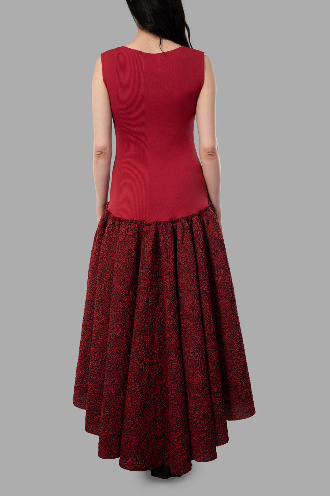 Marc Point Long Bustier Dress in Red, highlighting the detailed floral texture of the skirt, displayed from the left side.