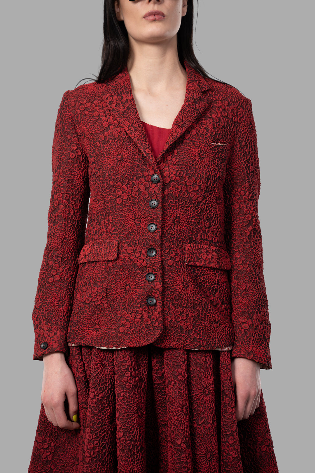 Marc Point Floral Jacket in red, featuring intricate texture and sculptural design, shown on-model with a relaxed fit.