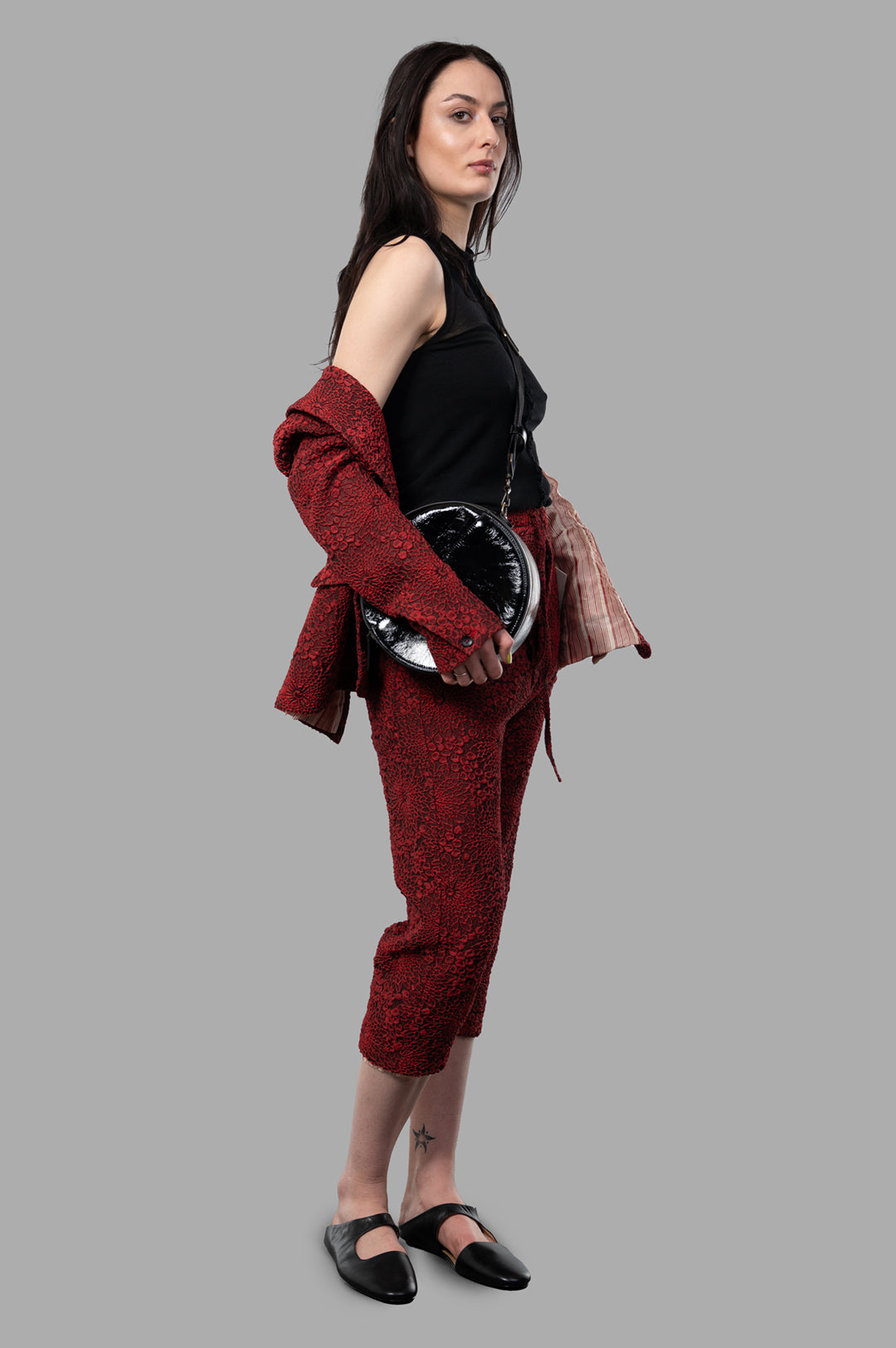 Marc Point Floral Capri Pants in red, side view on-model, featuring textured details and relaxed tailoring.