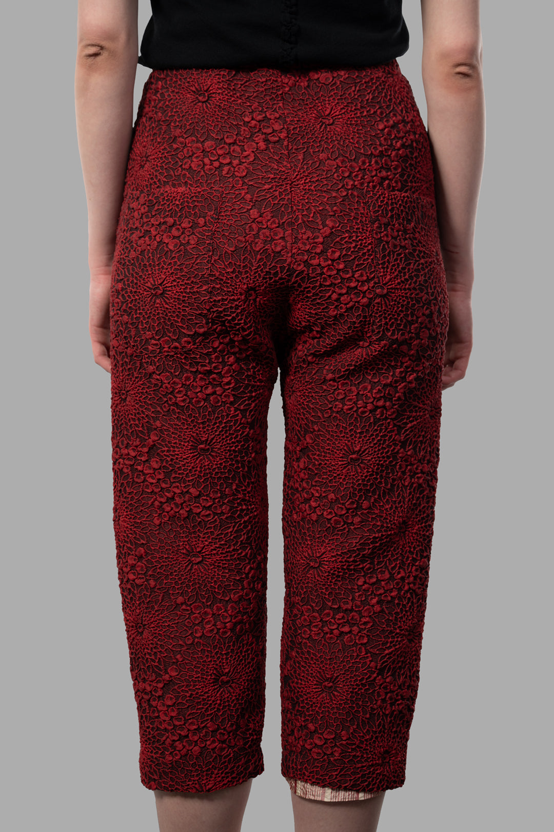 Marc Point Floral Capri Pants, showcasing intricate textured floral design, viewed from the back in rich red color.