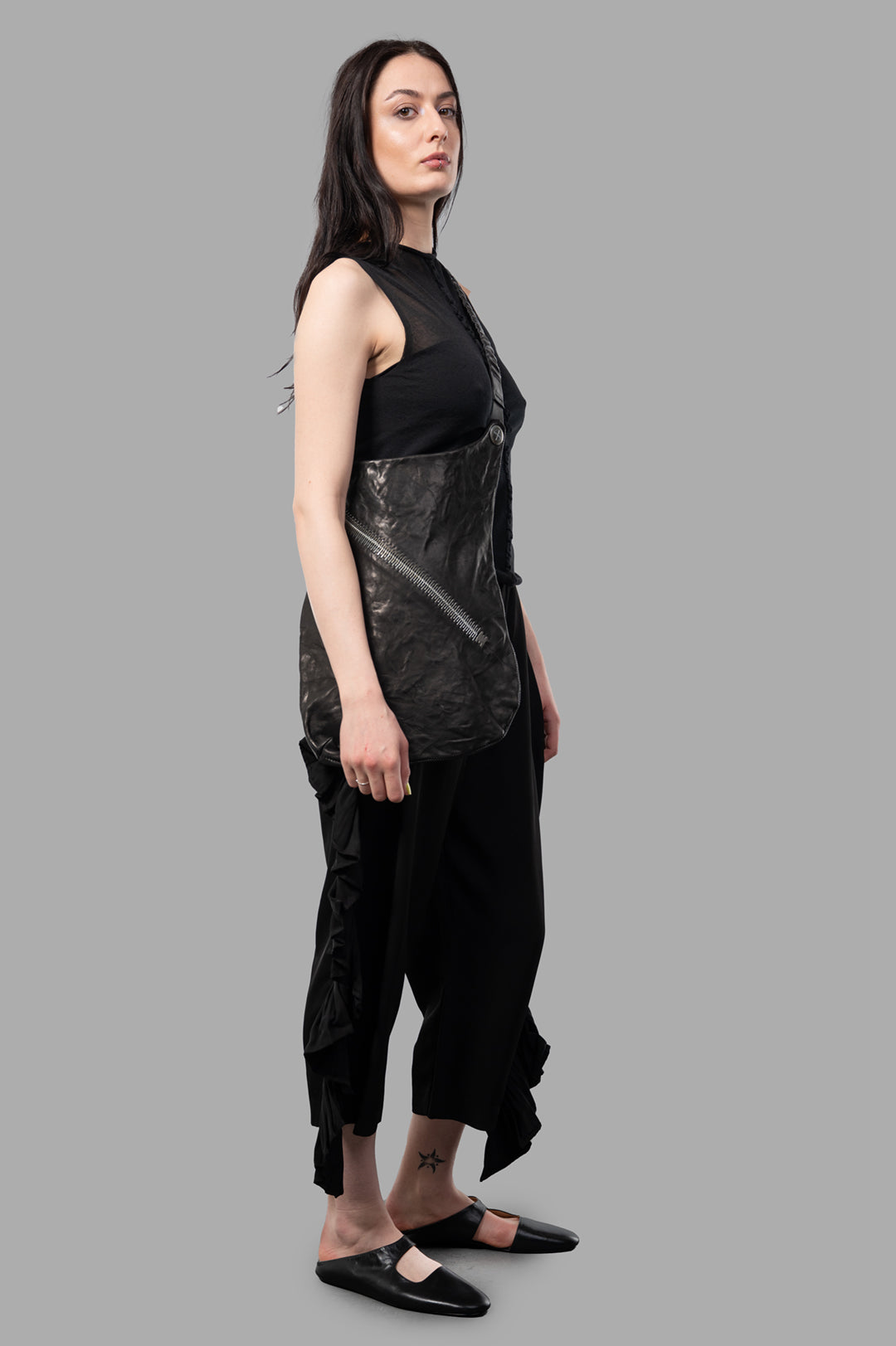 Uma Wang semi-transparent top in black, side view on model, showing layered design with textured natural fabrics.