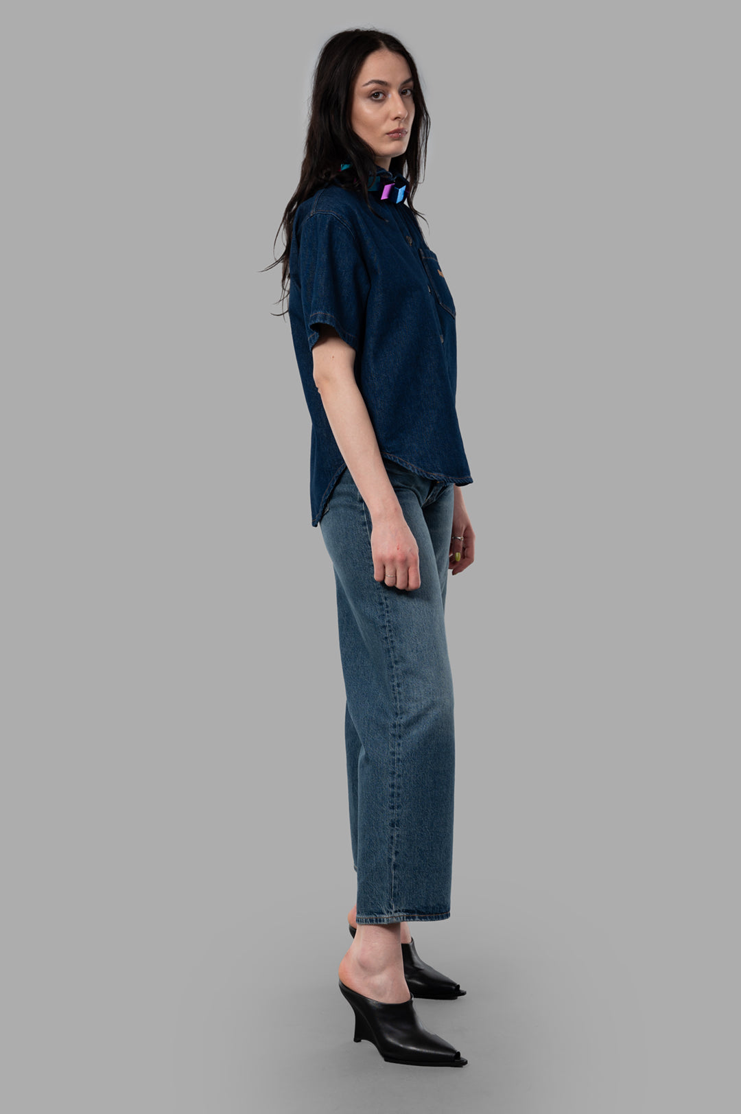 MSGM Open-Back Denim Shirt in blue, side view on model. Made from 100% cotton. Elegant Italian style.