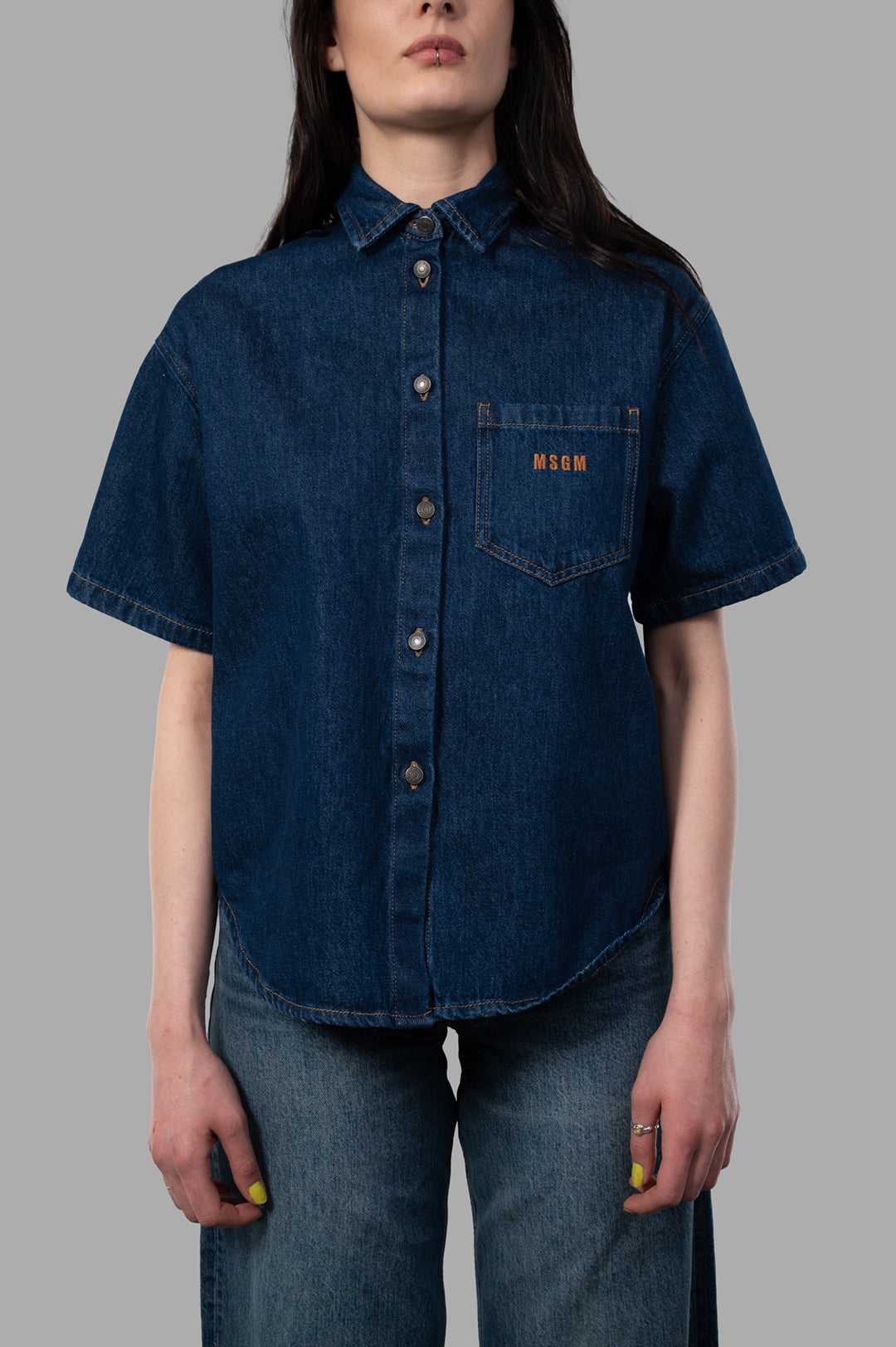 MSGM Open-Back Denim Shirt shown in front view, featuring a relaxed fit, short sleeves, and chest pocket with logo.