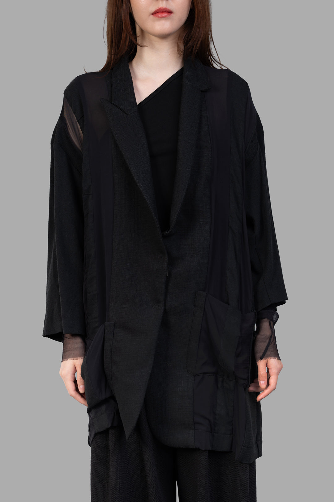 Giovanni Cavagna Paneled Blazer in black, showcasing a relaxed fit, unique textures, and layered detailing on model.