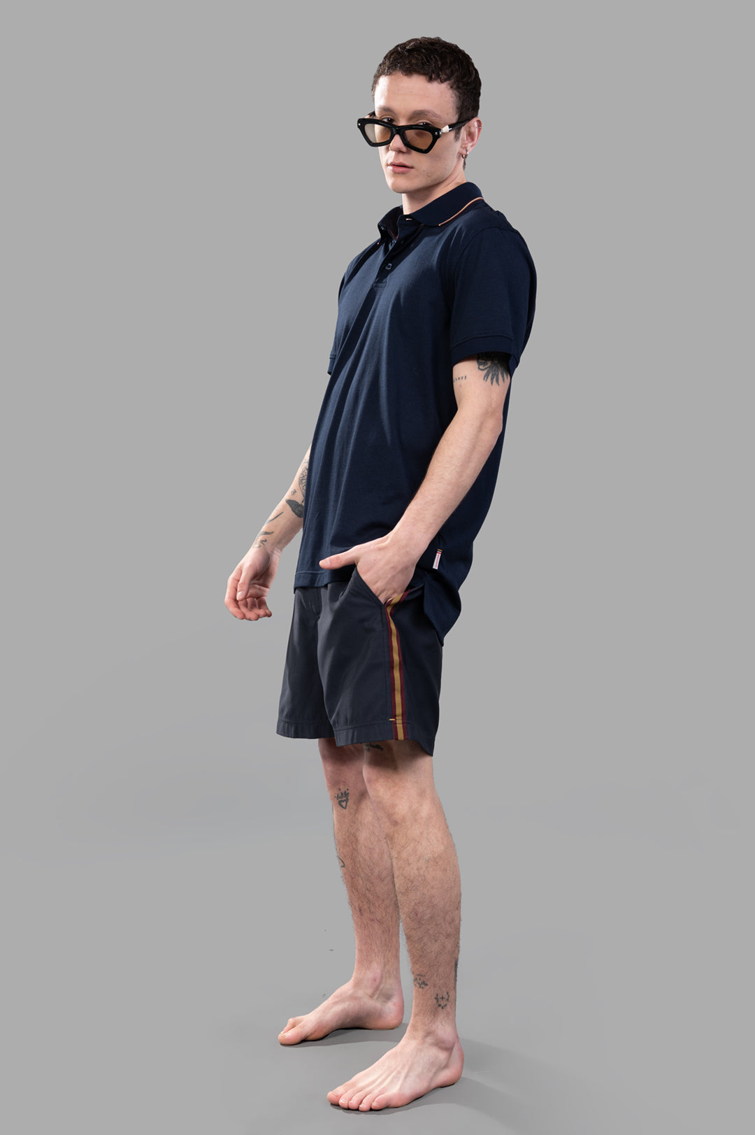 Orlebar Brown Dominic Polo Shirt in Navy Blue with contrast tipping, front-on view on model wearing sunglasses.