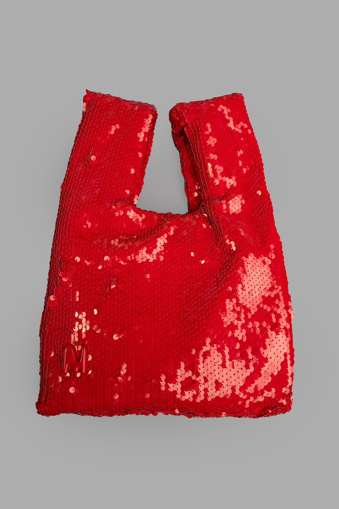 MSGM Red Paillettes Bag, front view showcasing vibrant sequin texture and modern design on gray background.