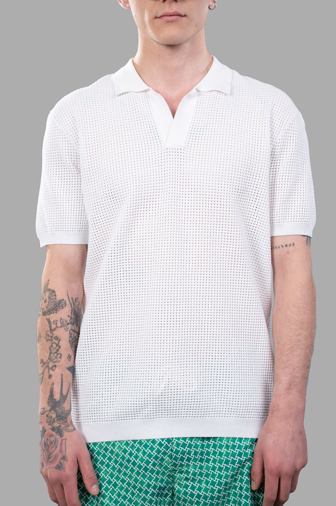 Orlebar Brown Waffle Mesh Polo Shirt in white, showcasing textured fabric and open placket design on model.