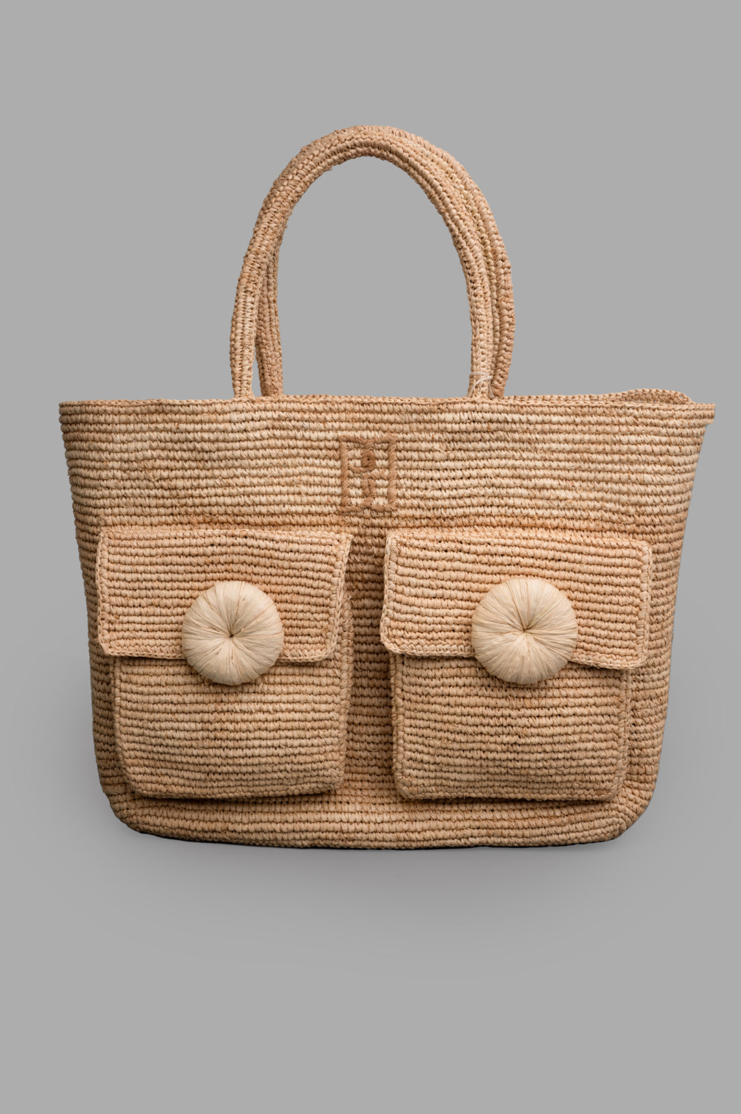 By Malene Birger Miras Tote Bag, raffia front view with floral appliqué buttons, dual pockets, embroidered monogram.