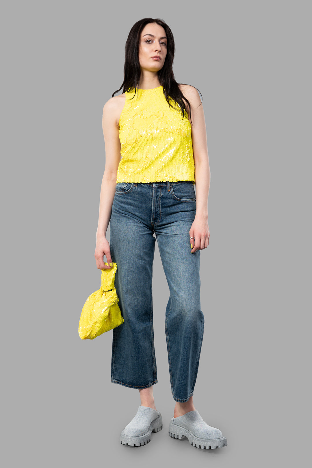 MSGM Yellow Sequin Top on model, showcasing front view with dynamic Italian style, paired with jeans and clogs.