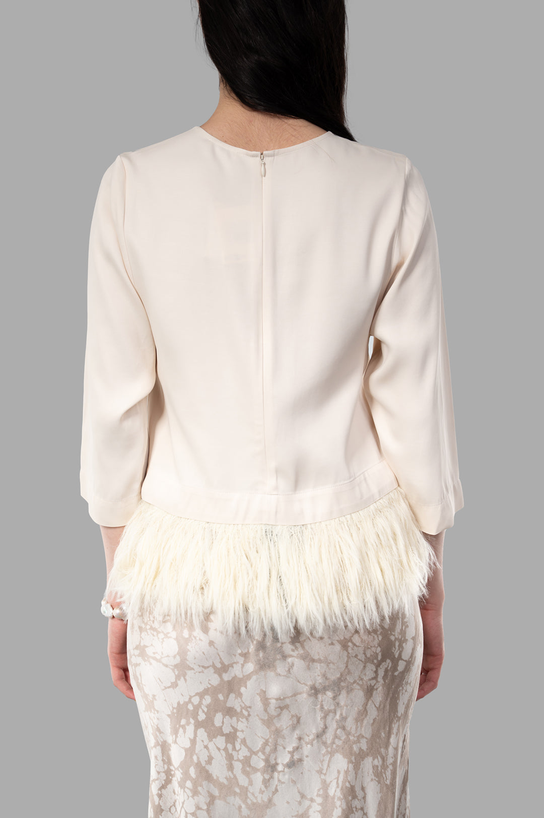 By Malene Birger. Back view of Scarletts Blouse featuring detachable feathers, round neckline, and cropped sleeves. Color.