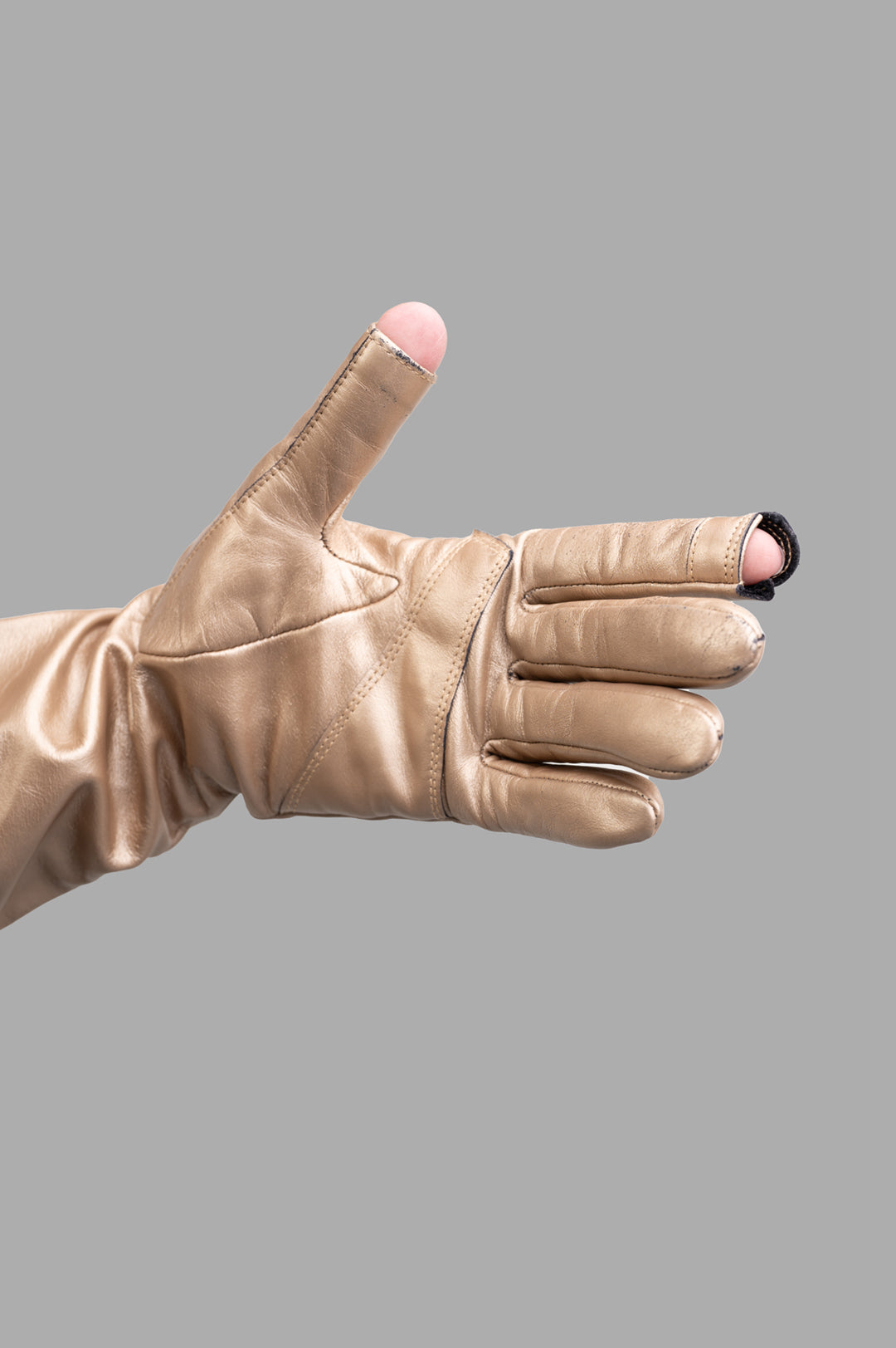 Rick Owens Hollywood Runway Gauntlets displayed in gold calf leather, highlighting the unique cut-outs from a top angle.