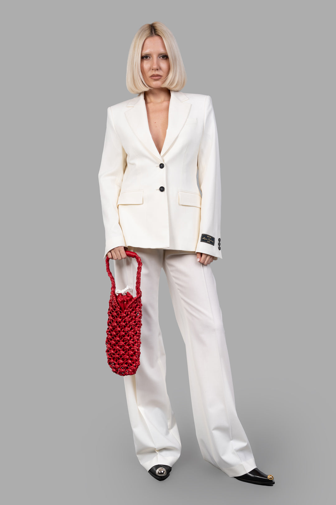 MSGM wide-leg trousers in ecru, front view on model, paired with matching blazer, showcasing tailored pleats.