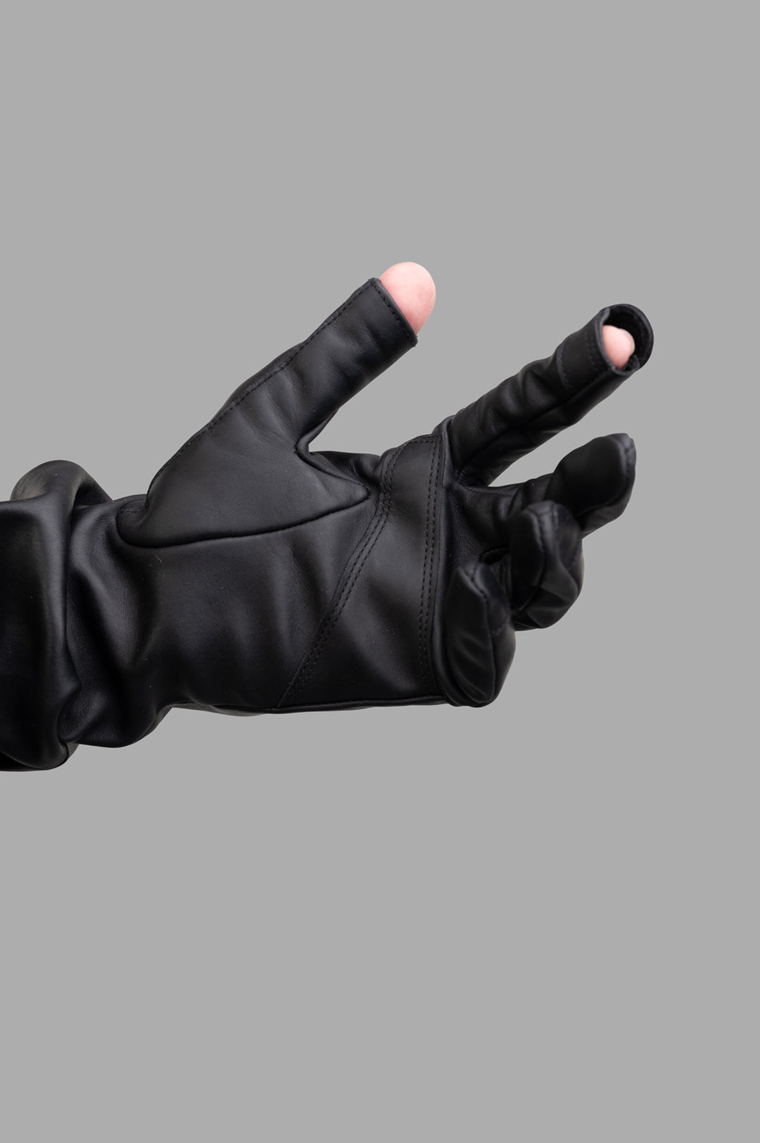 Rick Owens Hollywood Runway Gauntlets in Black, close-up of mediumweight calf leather with cut-out fingertips.