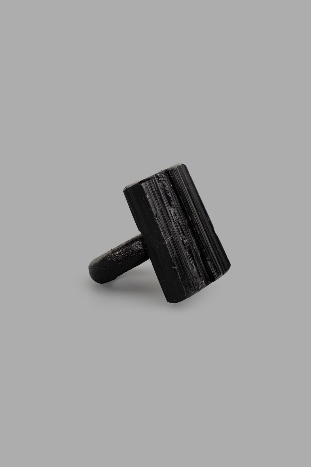 Monies black textured ring, front view showcasing raw turmaline material, blending art with bold design.