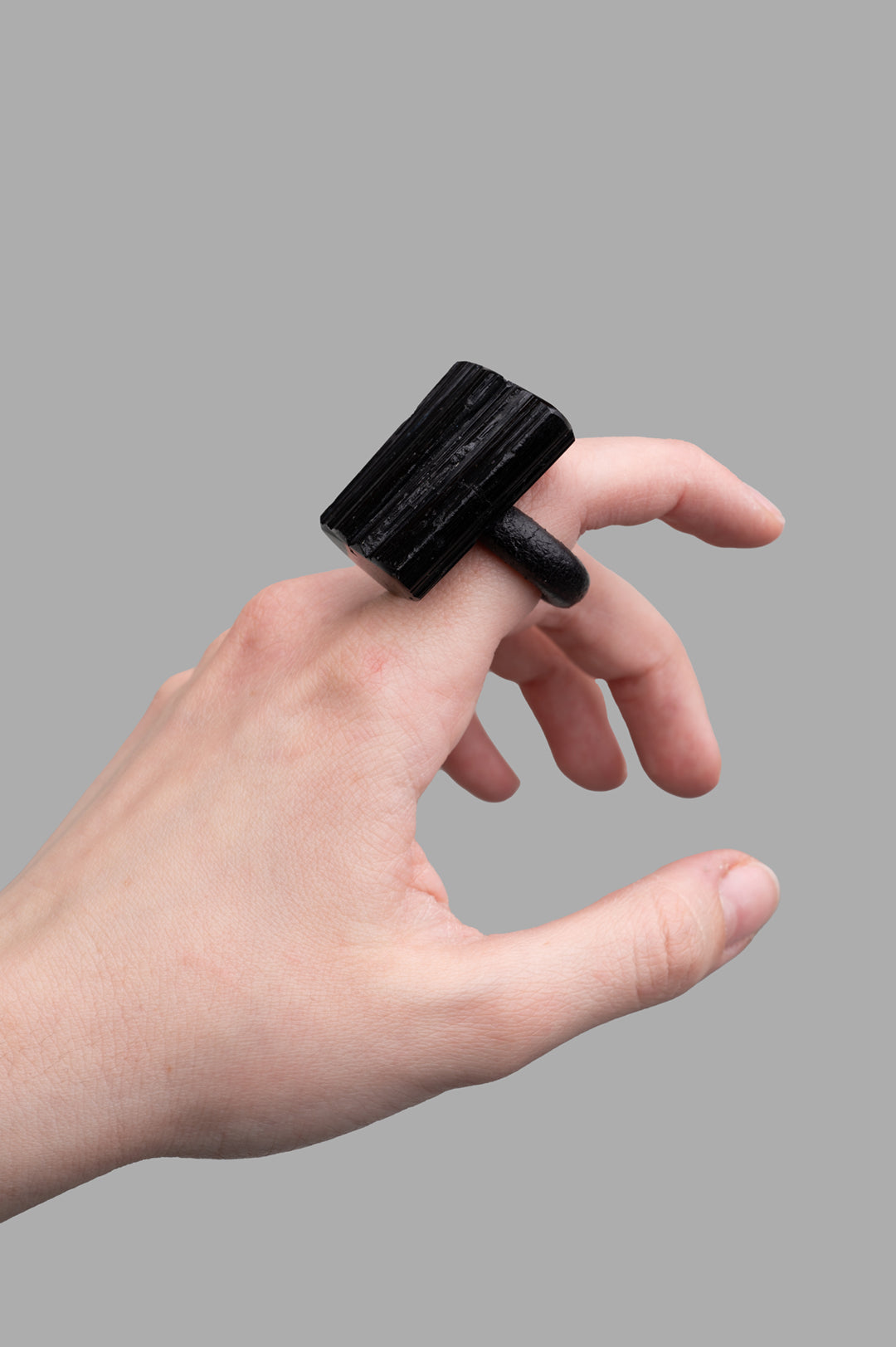 Monies Textured Ring in black turmaline, showcasing unique design on model's hand, highlighting raw, artistic material.