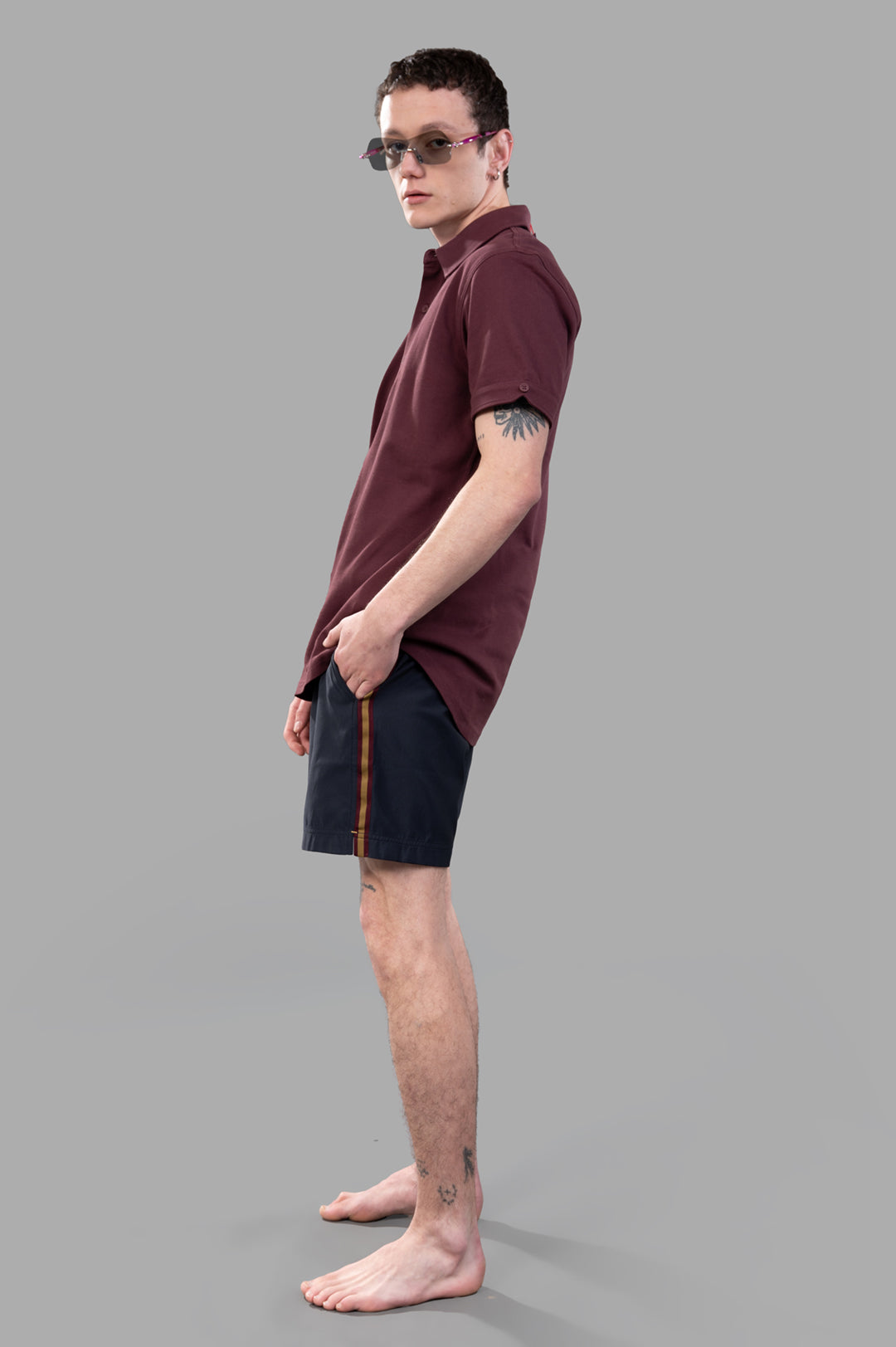 Orlebar Brown Sebastian Polo Shirt in Burgundy Red, side view on-model, featuring a relaxed yet tailored fit.