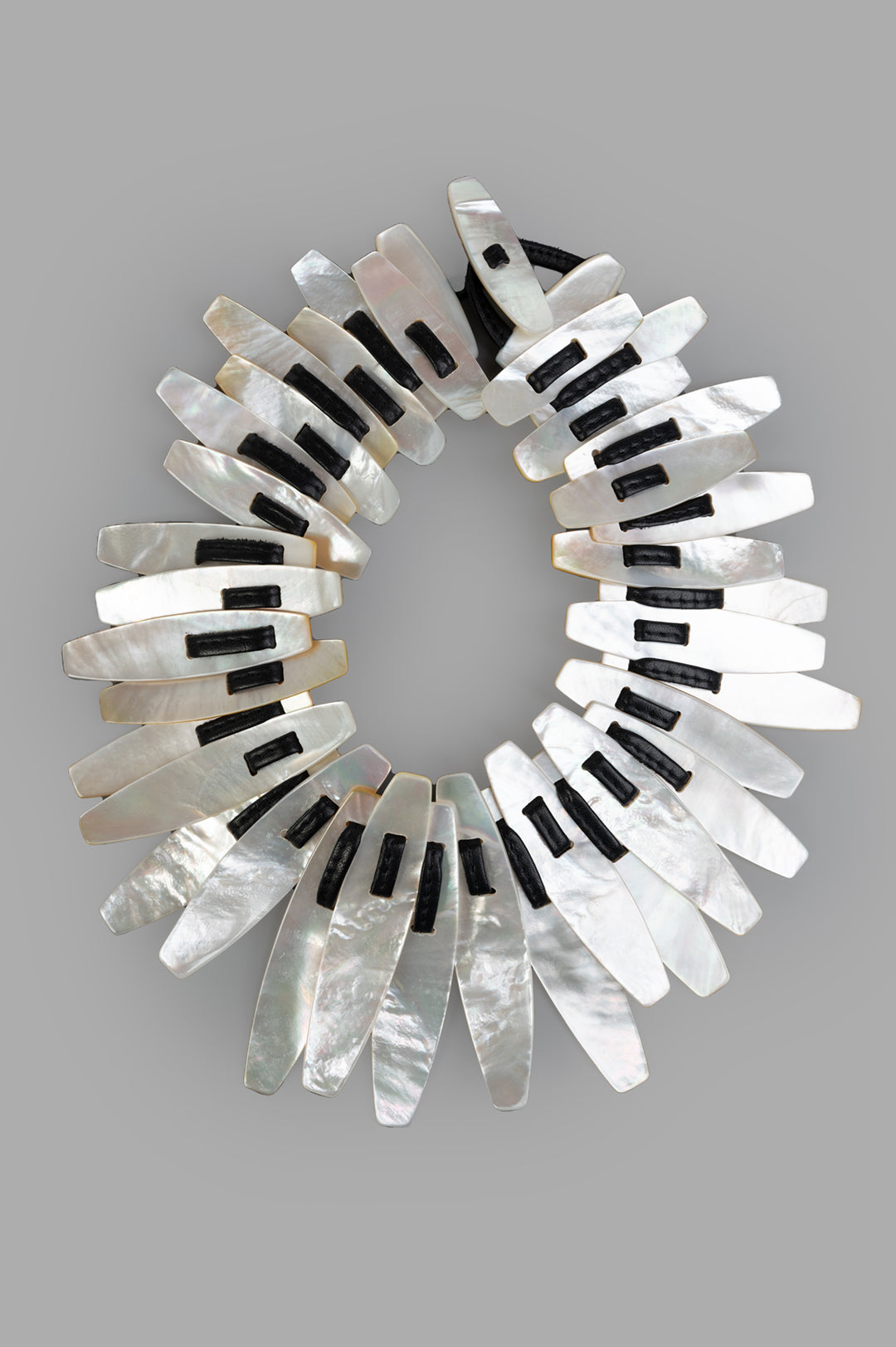 Monies Mother of Pearl Necklace, close-up showing intricate white and black layered design, highlighting texture.