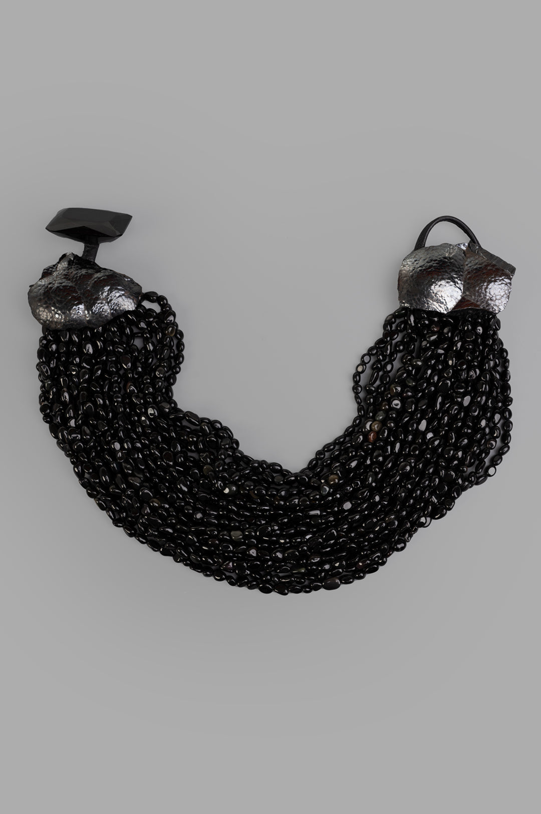 Monies Beaded Necklace, close-up detail view of multi-strand black beads with textured silver accents.