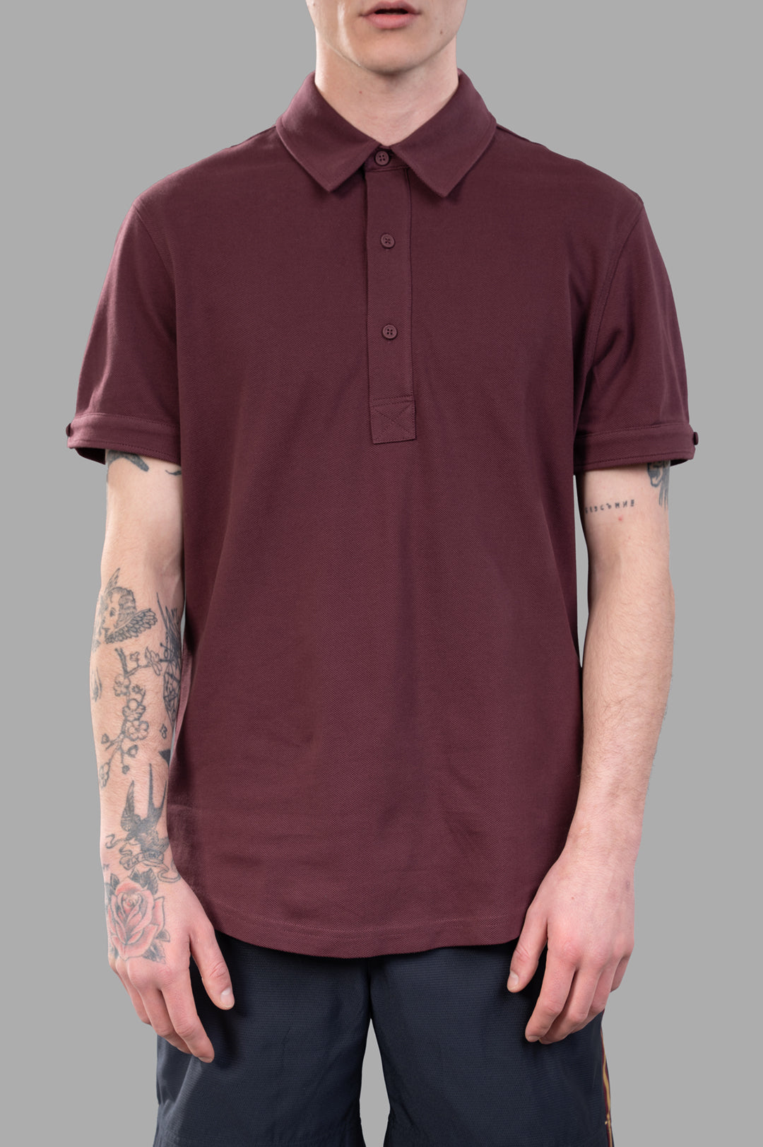 Orlebar Brown Sebastian Polo Shirt in burgundy red, featuring a tailored fit, three-button placket, and rolled sleeves.