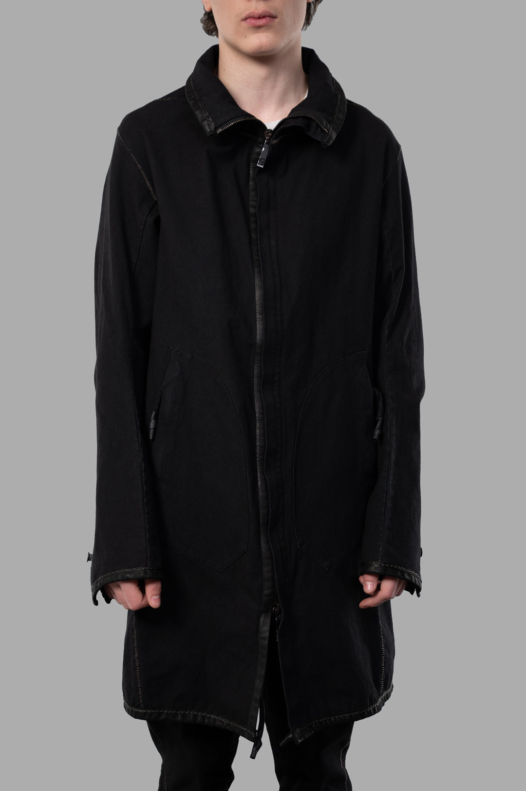 Isaac Sellam Zip-up Parka in black, showcasing a front view with unique architectural cuts and detailed stitching.