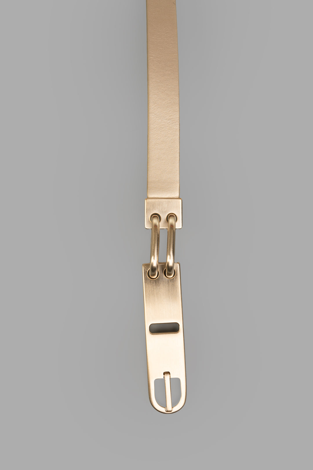 Rick Owens Snap Hook Belt featuring a sleek gold finish and distinctive buckle detail, showcasing premium calf leather.
