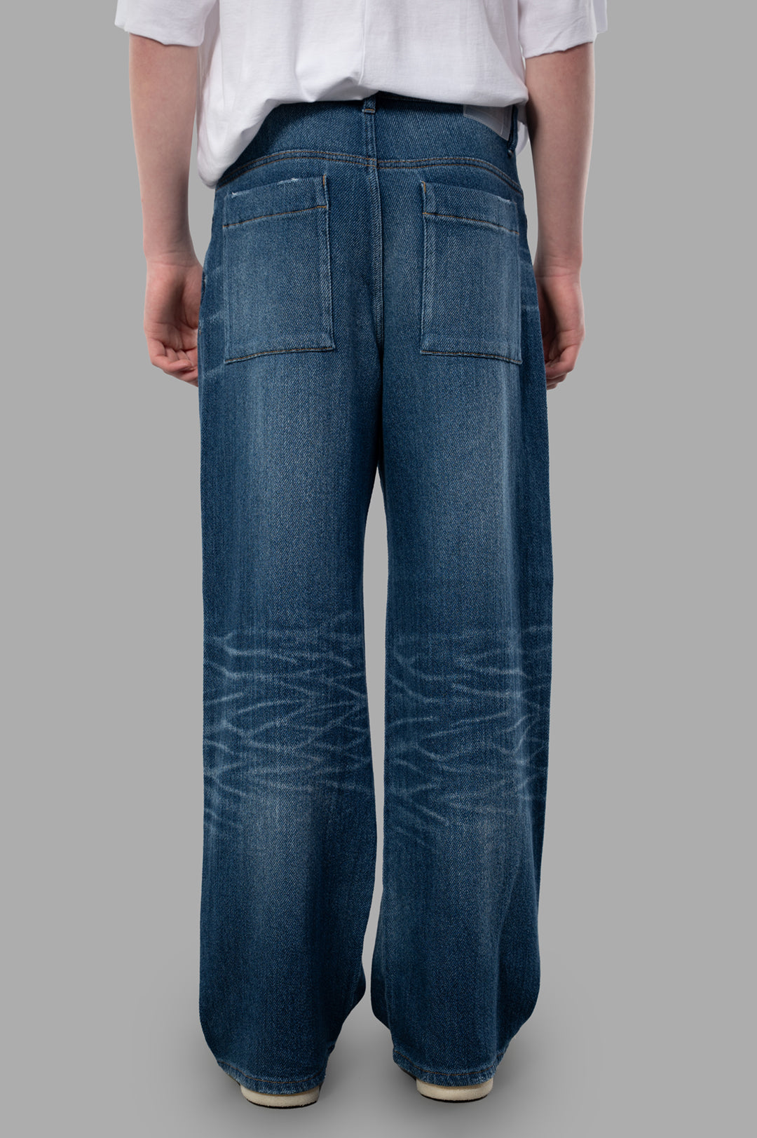 Vein Wide-leg Jeans viewed from the back, showcasing the spacious fit and stylish blue cotton fabric with pockets.