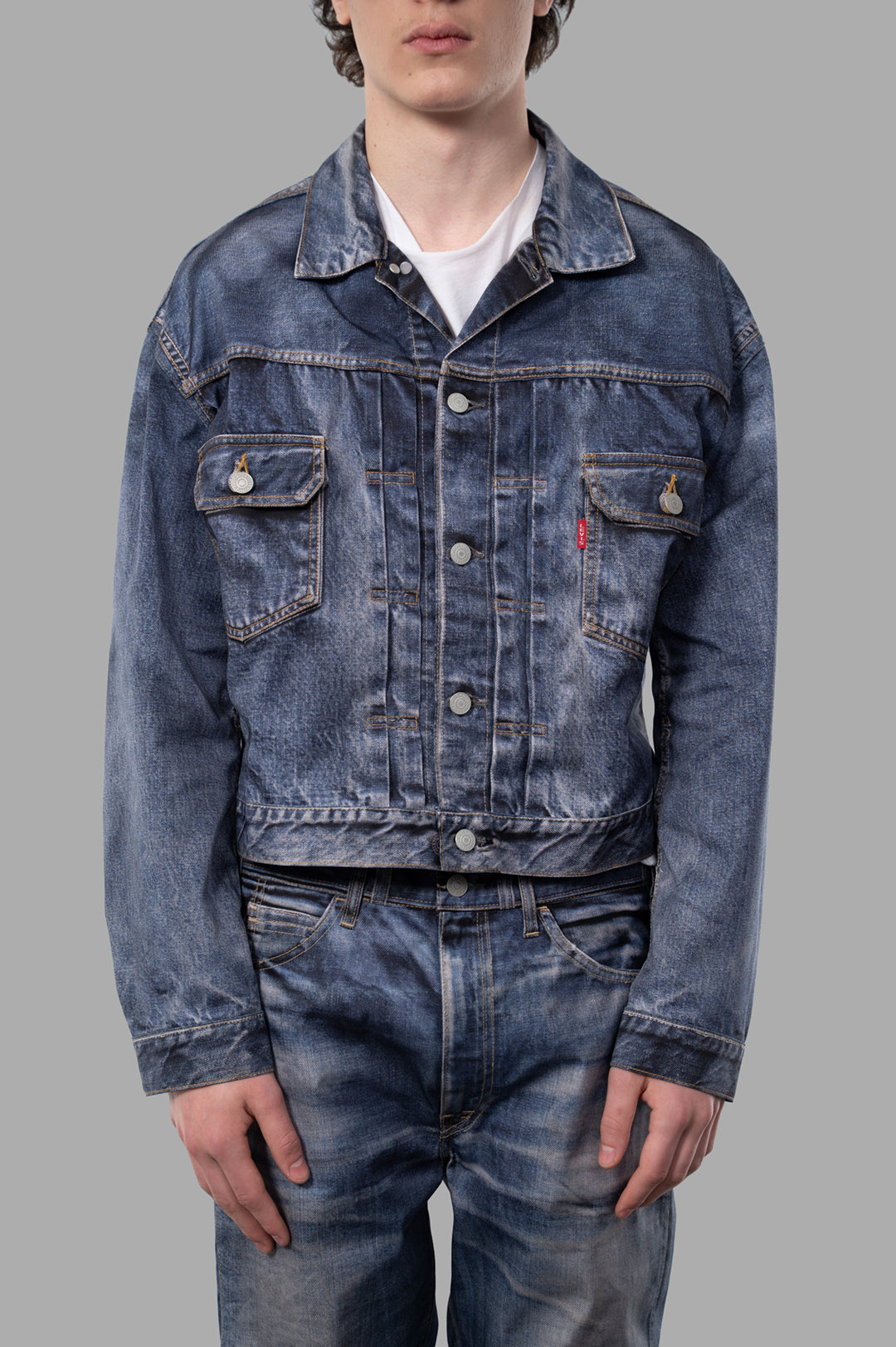 Junya Watanabe x Levi's Nylon Twill Jacket displayed on model, featuring buttoned cuffs and chest flap pockets in blue denim.