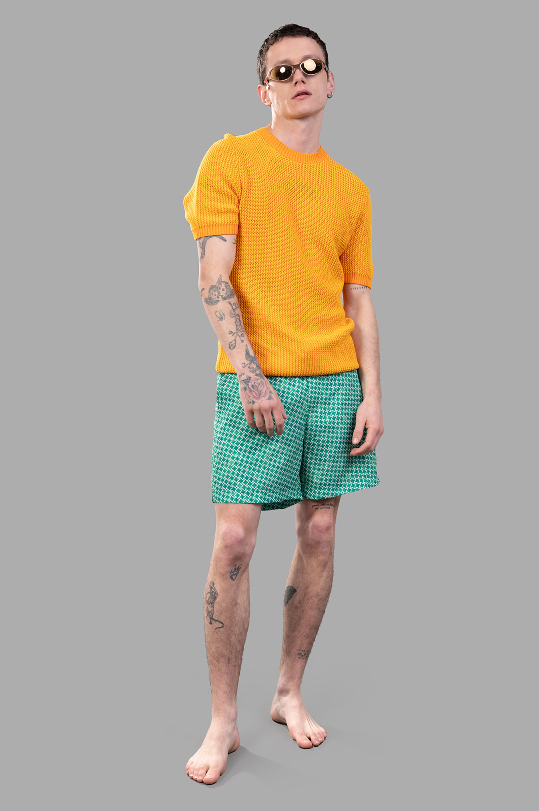 Orlebar Brown Chevron Knit T-Shirt in orange, modeled front view. Features ribbed trims and textured chevron pattern.