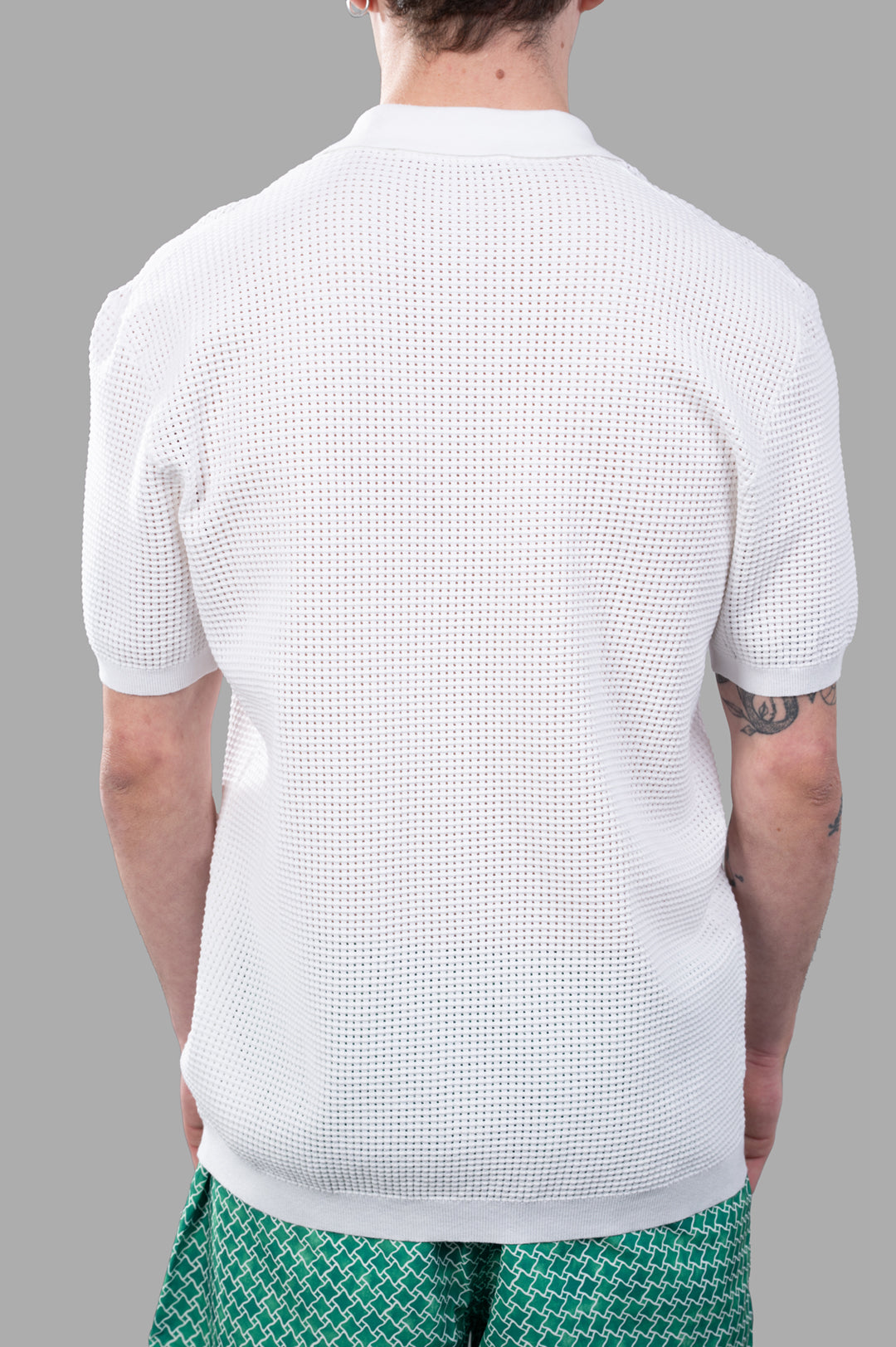 Orlebar Brown Waffle Mesh Polo Shirt, showcasing textured knit design and open resort placket, viewed from the back.