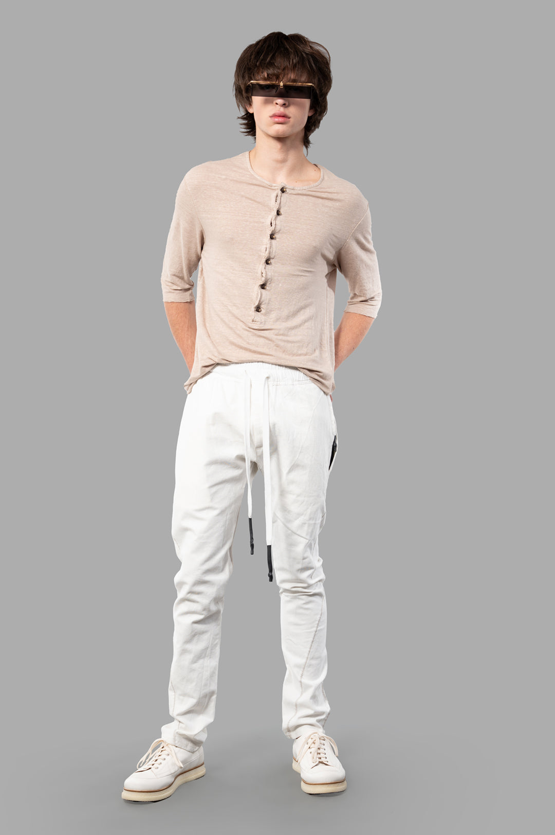 Isaac Sellam Drawstring Trousers, white, front view on-model, showcases modern menswear with meticulous detailing.