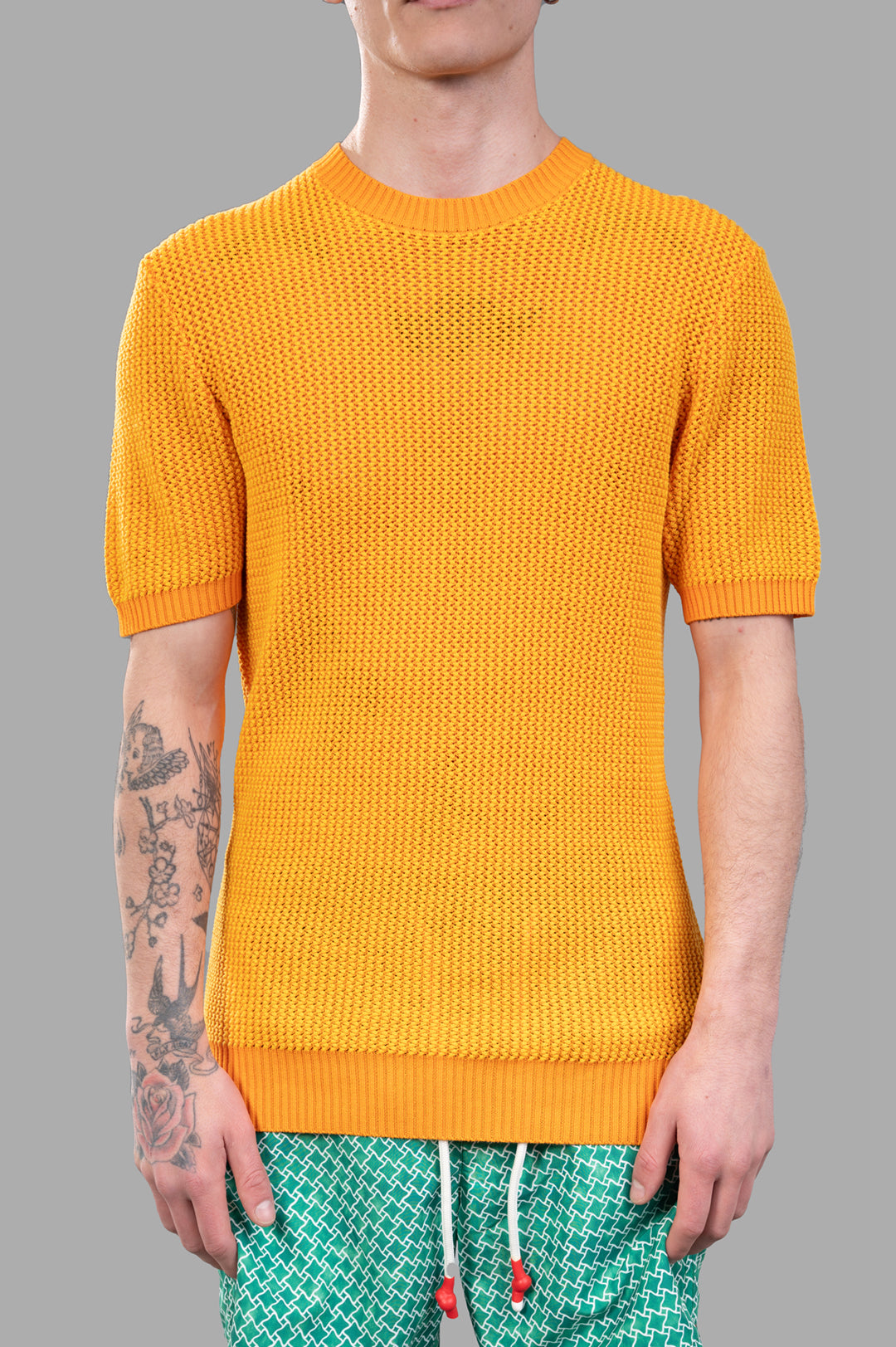Orlebar Brown Chevron Knit T-Shirt showcases a vibrant orange knit design with ribbed neck and cuffs, ideal for sunny days.