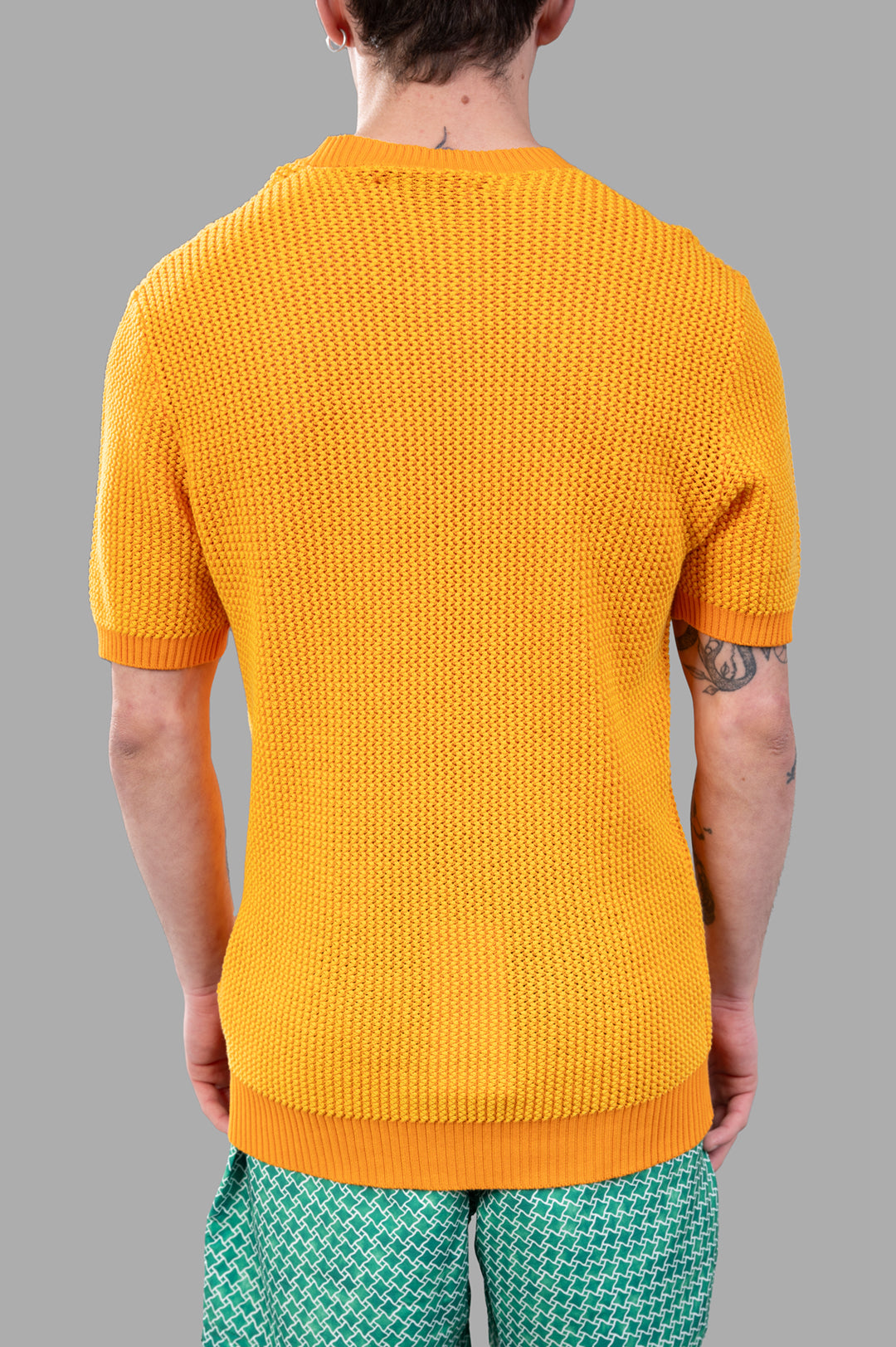 Orlebar Brown Chevron Knit T-Shirt in vibrant orange, showcasing a stylish crochet texture and thick ribbed details on model.