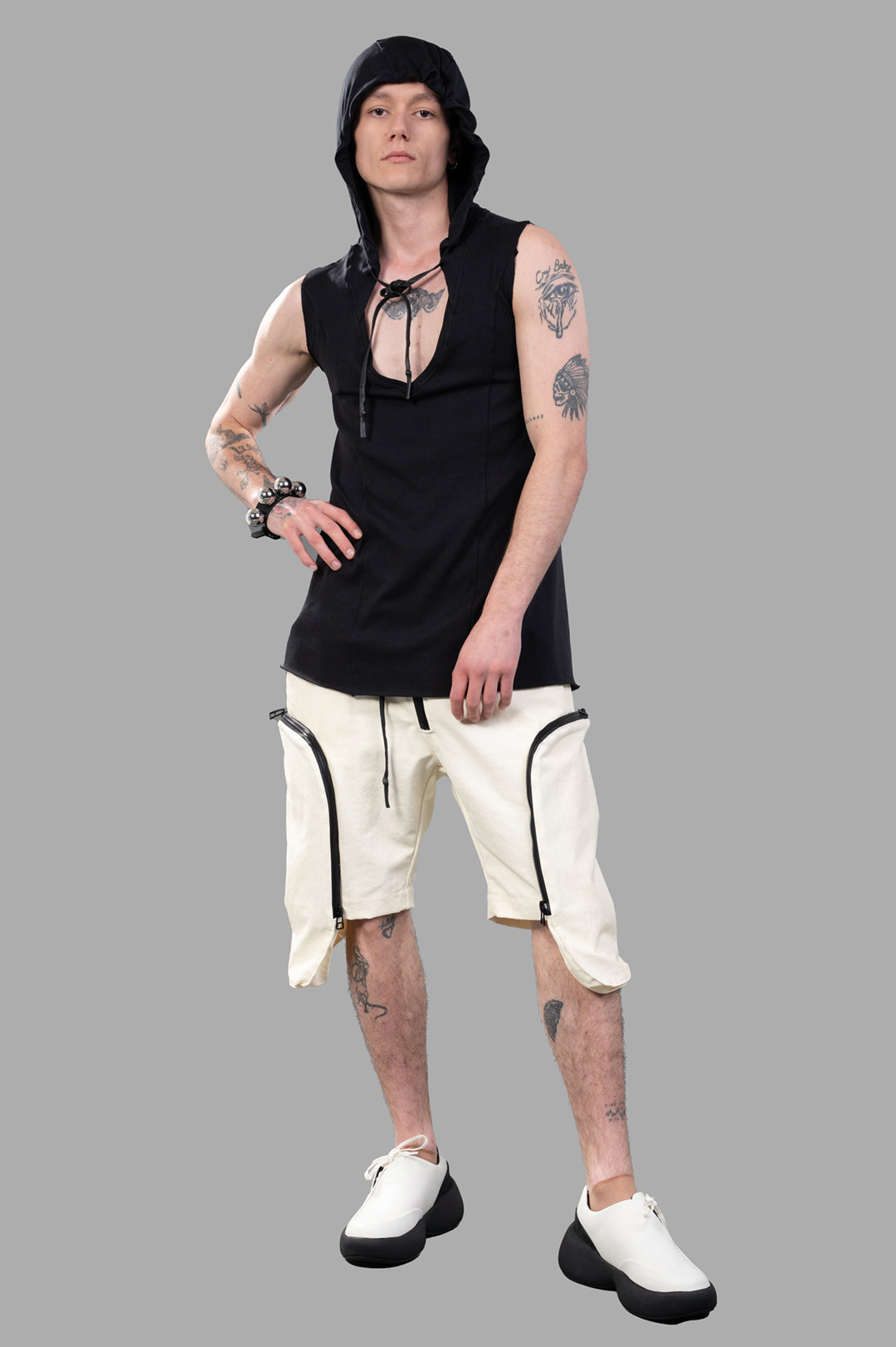 Justin Gall Cargo Floater Shorts front view on-model with black sleeveless hoodie, showcasing zipper detail.