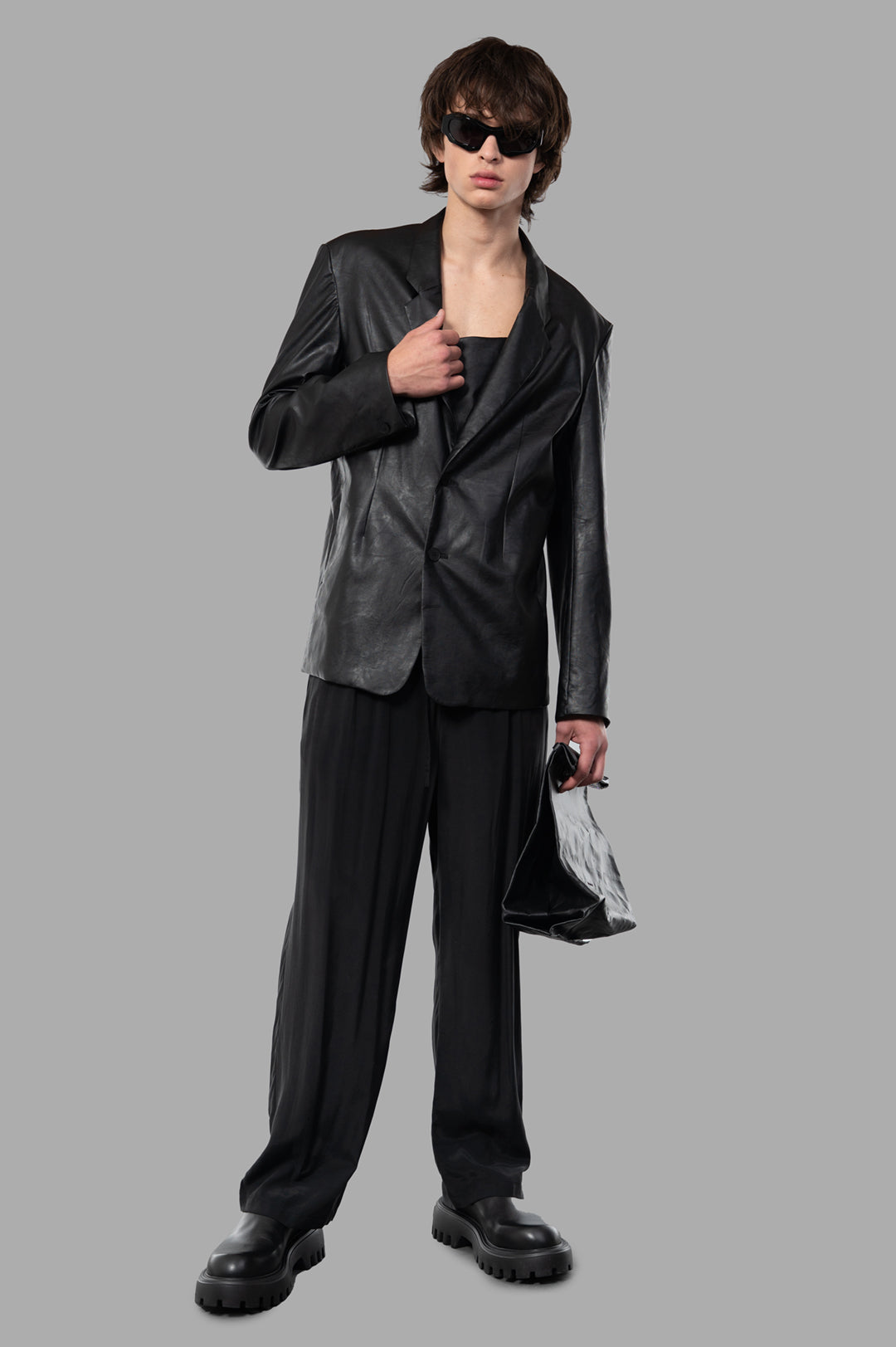 Vein black synthetic leather jacket front view on model, showcasing sleek, lightweight design and effortless style.