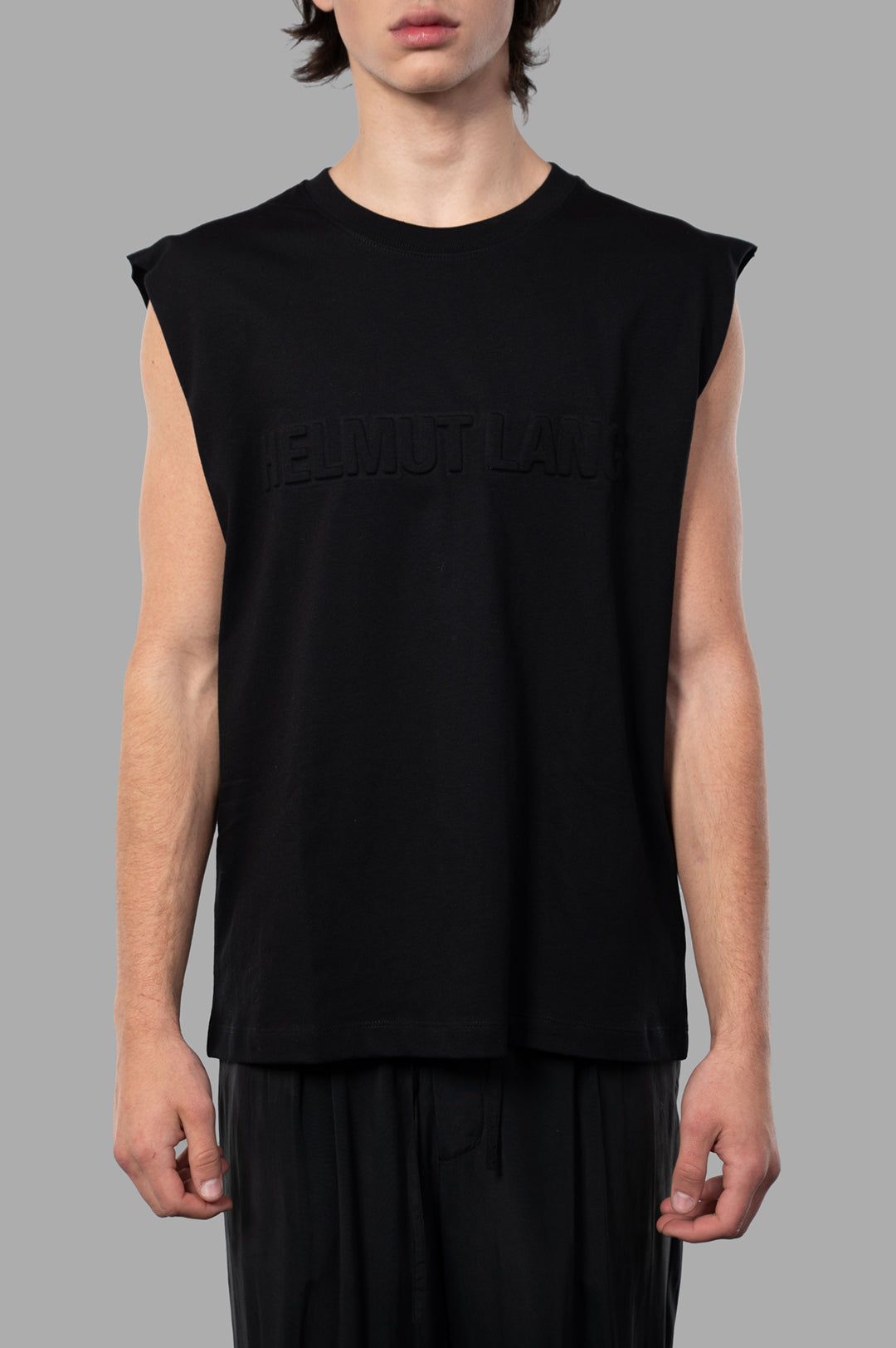 Helmut Lang Embossed Logo Tank, black crewneck tank top on model highlighting embossed logo and relaxed-fit design.