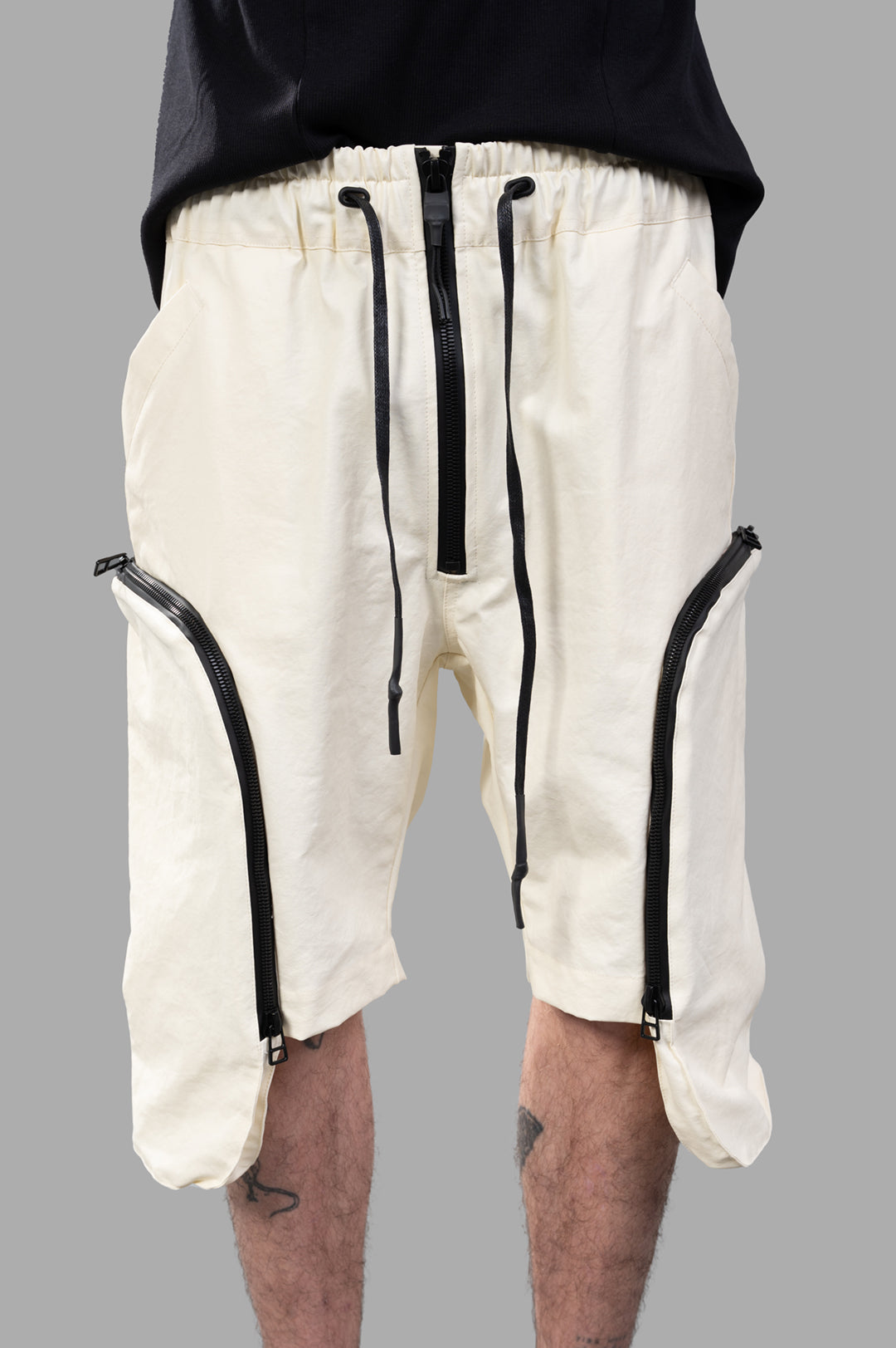 Justin Gall Cargo Floater Shorts feature a relaxed fit with black zippers and an elastic waistband, styled on-model.