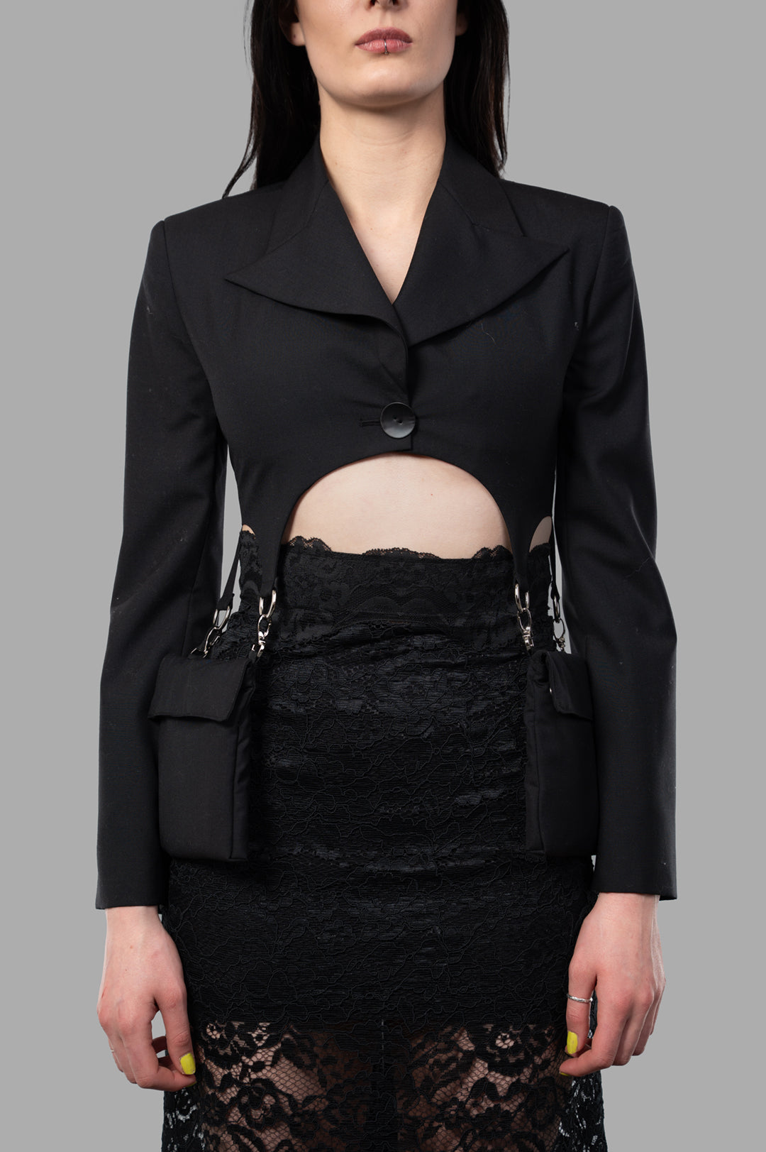 Sehnsucht Atelier Cropped Cargo Blazer in black, showcasing a unique cutout design and structured silhouette on model.