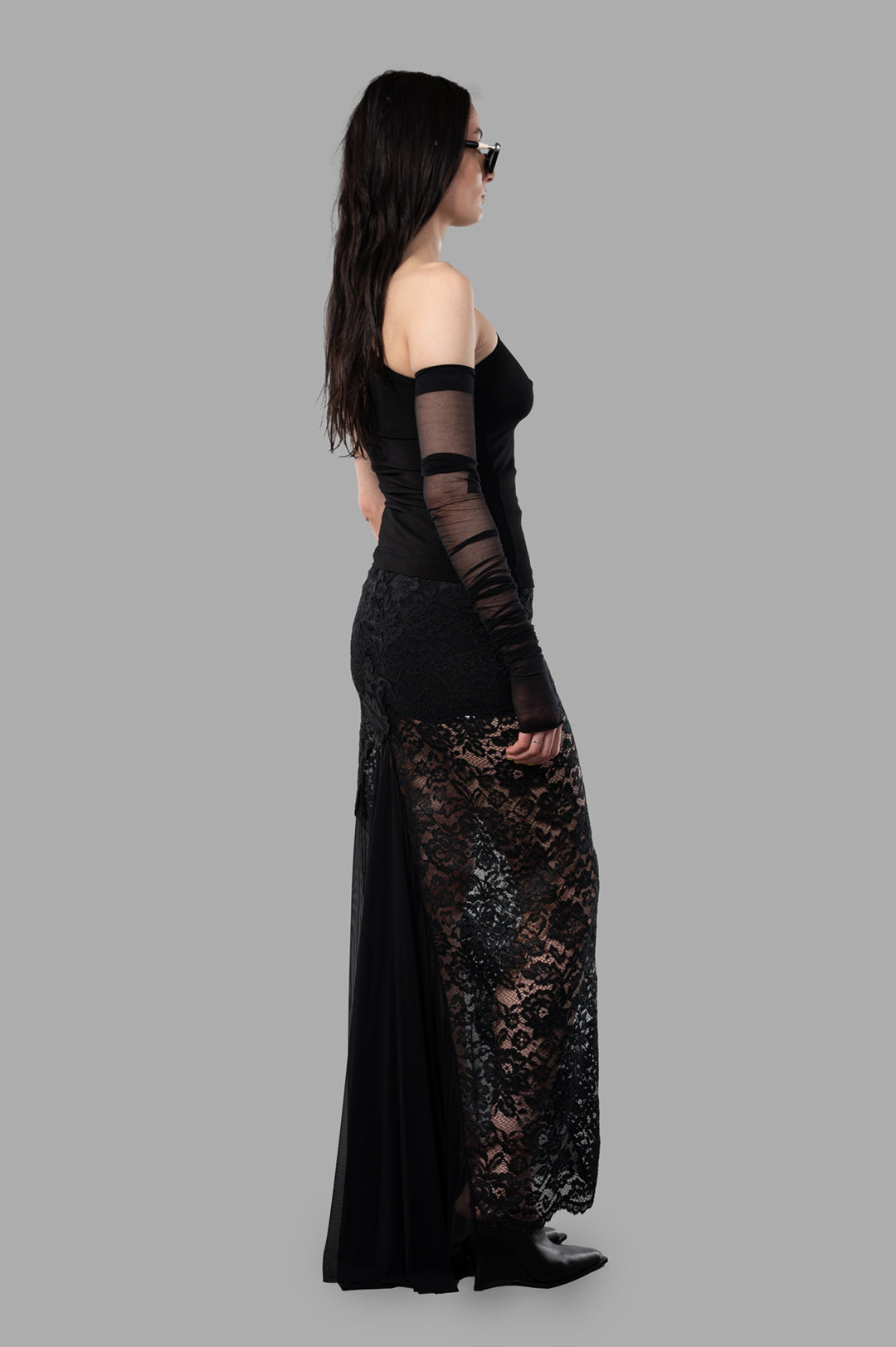 Sehnsucht Atelier Lace Maxi Skirt in black, side view on model, semi-transparent design with Victorian and steampunk flair.