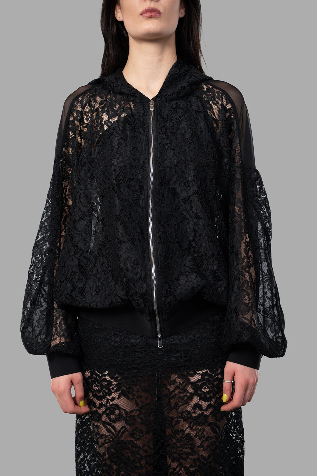 Sehnsucht Atelier Lace Hoodie in black, featuring oversized lace design, front view with zip closure, and sheer sleeves.
