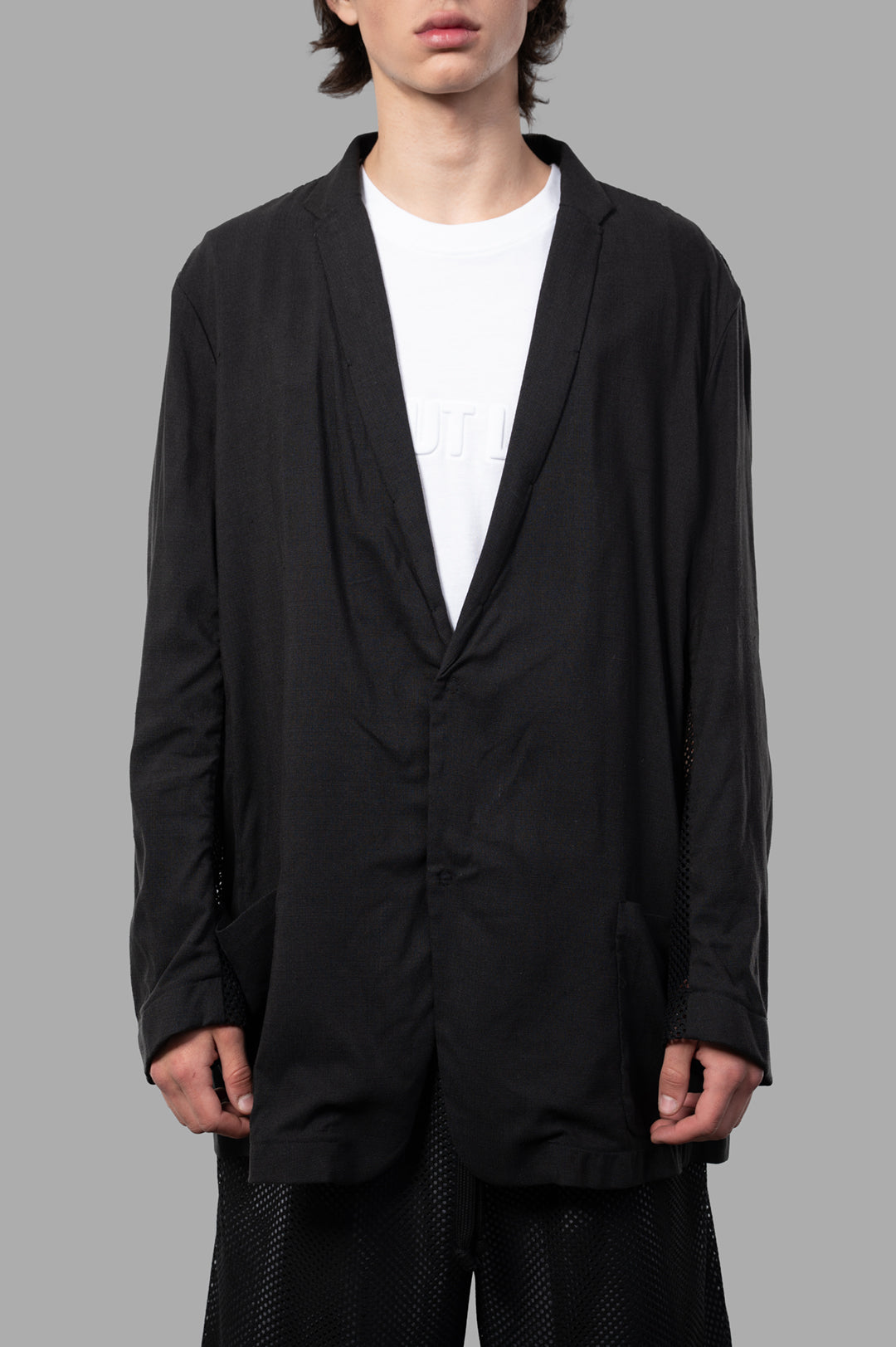 Giovanni Cavagna Semi-transparent Blazer features oversized design, single-button closure, and pockets in a black silk blend.