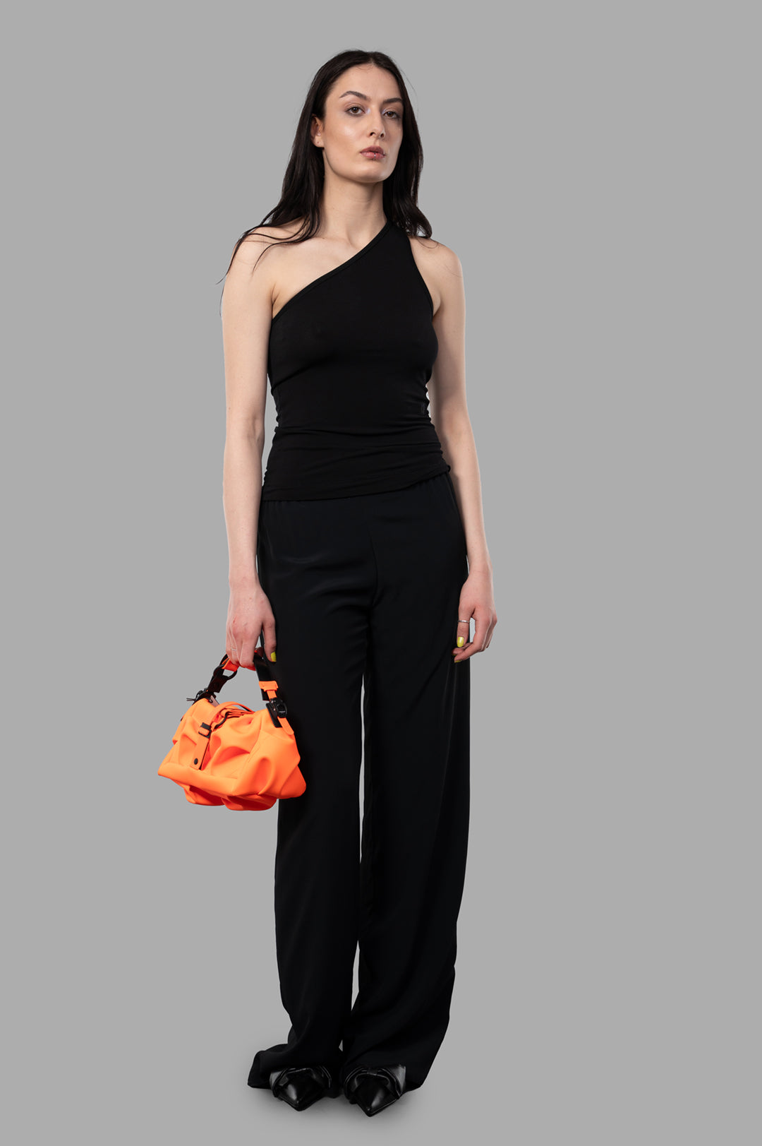 By Malene Birger Jaklin Top in black, asymmetrical one-shoulder style, front view on-model, minimalist summer design.