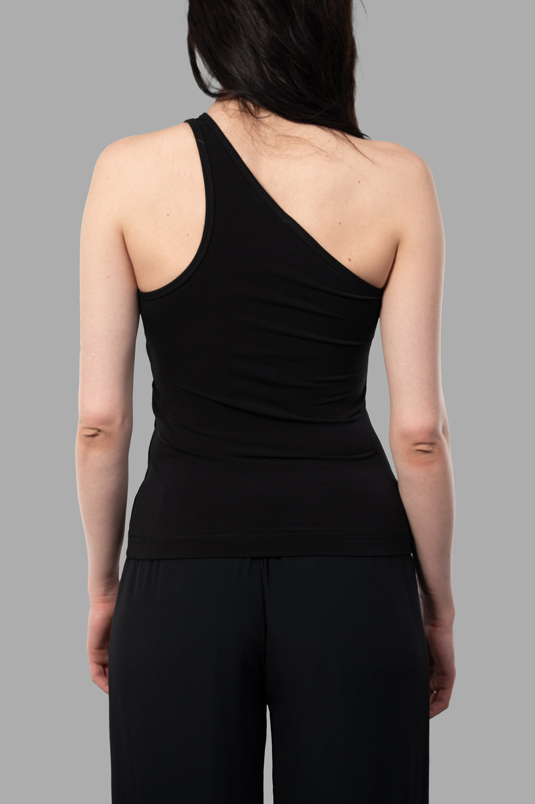 By Malene Birger Jaklin Top, black one-shoulder top displayed from the back, showcasing its sleek fit and minimalist design.