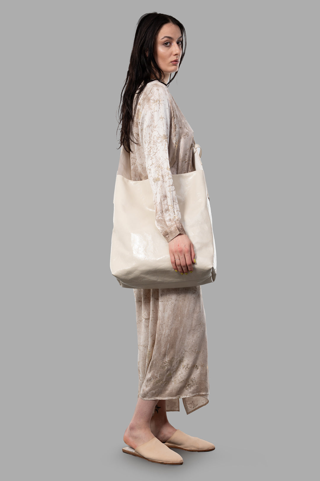 Avant Toi marble-print silk dress in dusty pink, side view on model, showcasing flowy design and long sleeves.