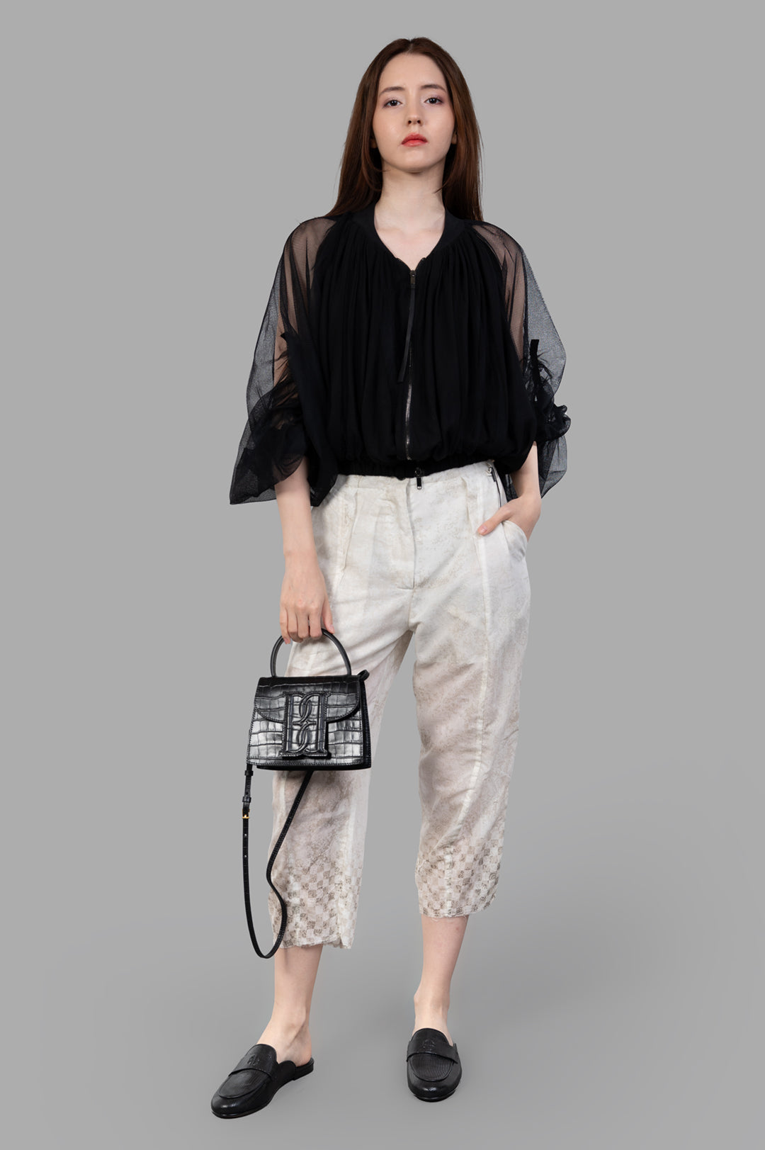 Masnada Cropped Trousers with graphic motif, front view on model in ecru, highlighting elevated waist and straight cut.