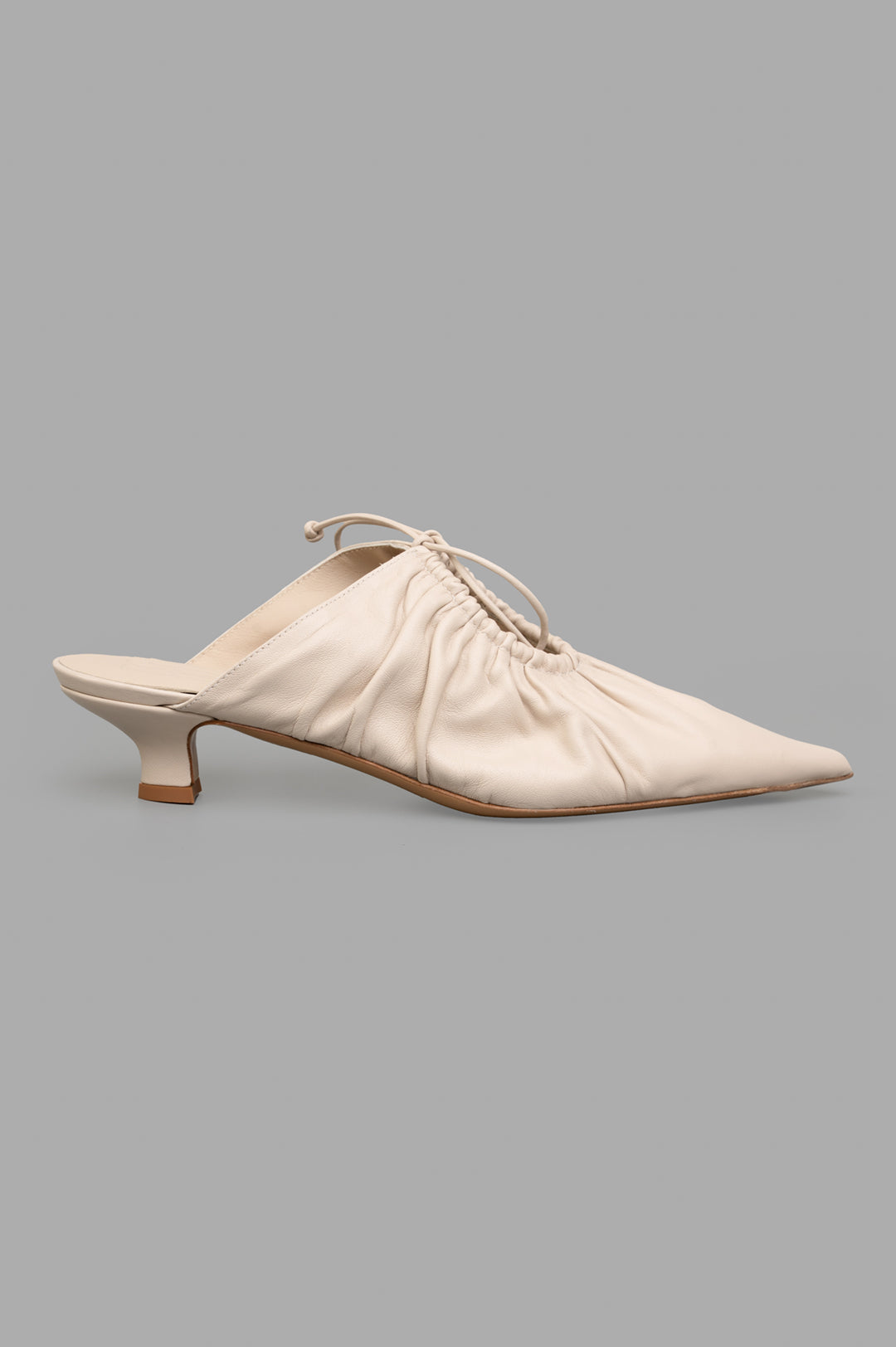 By Malene Birger Masey Leather Mules, side view, ecru goat leather, pointy toe, kitten heels, slim bow detail.