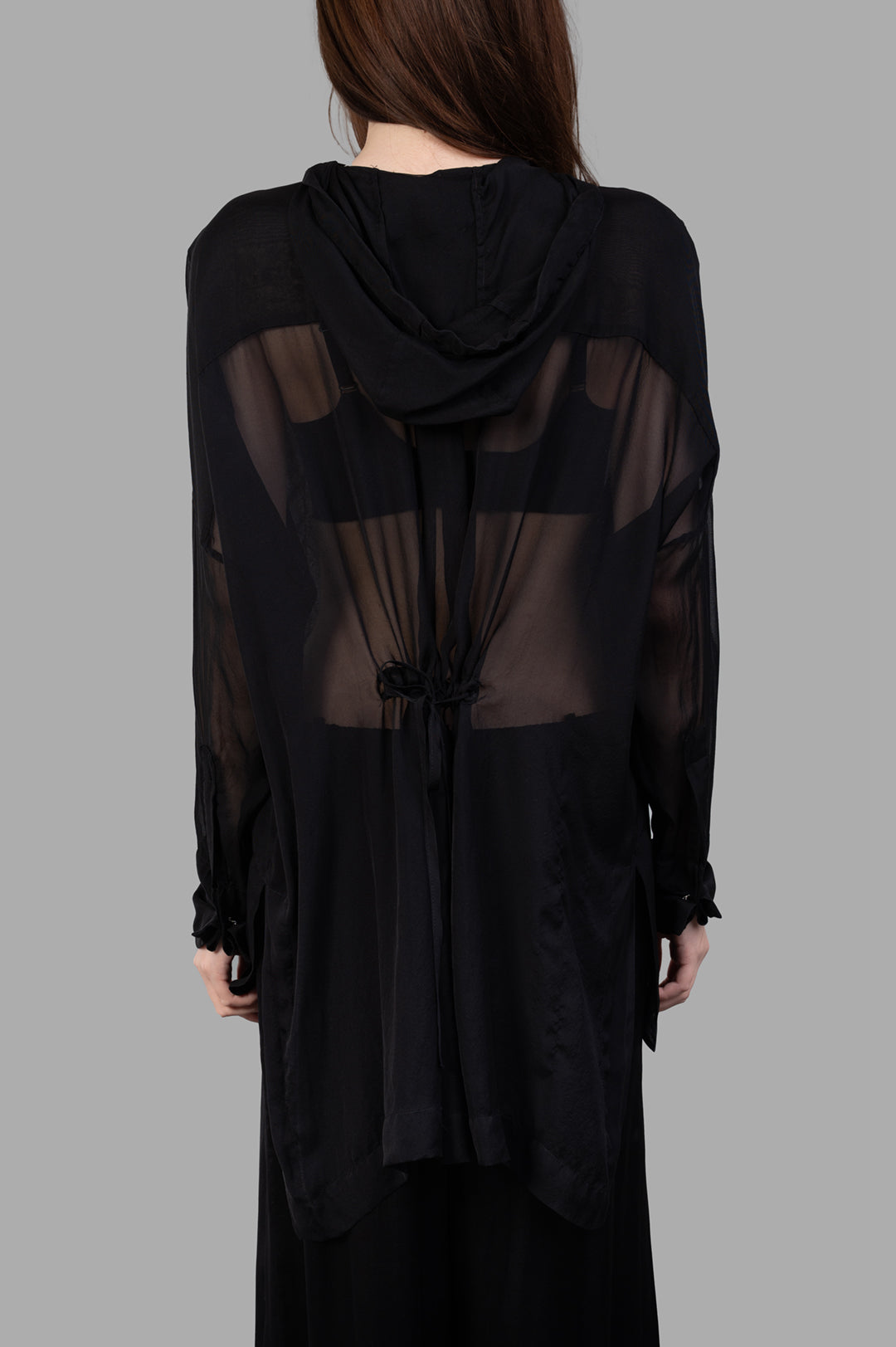Masnada Hooded Shirt shown from the back, featuring a hood, drawstring, and sheer black silk fabric for a lightweight look.