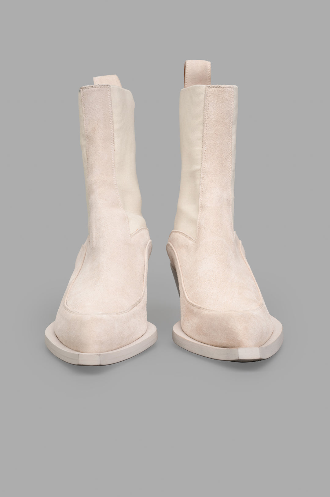Mattia Capezzani Suede Boots in ecru, featuring a sleek design with a sculptural shape, shown from the front.